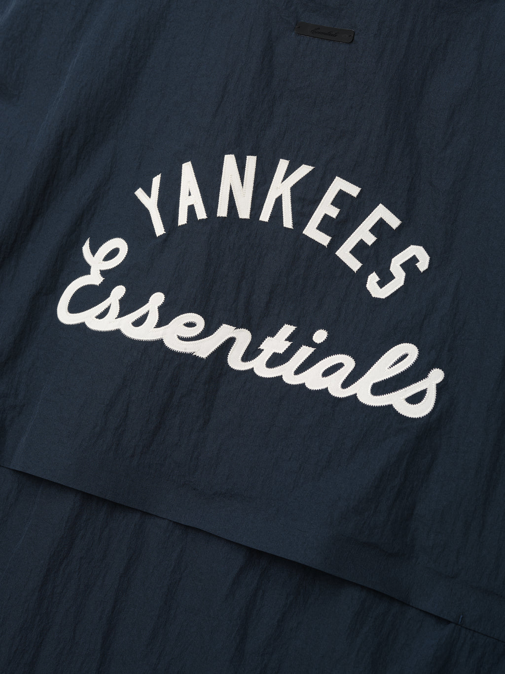 Yankees 3/4 Sleeve Pullover in dark sapphire featuring a lightweight fabric with "Yankees Essentials" printed in bold white script for a sporty yet casual look.