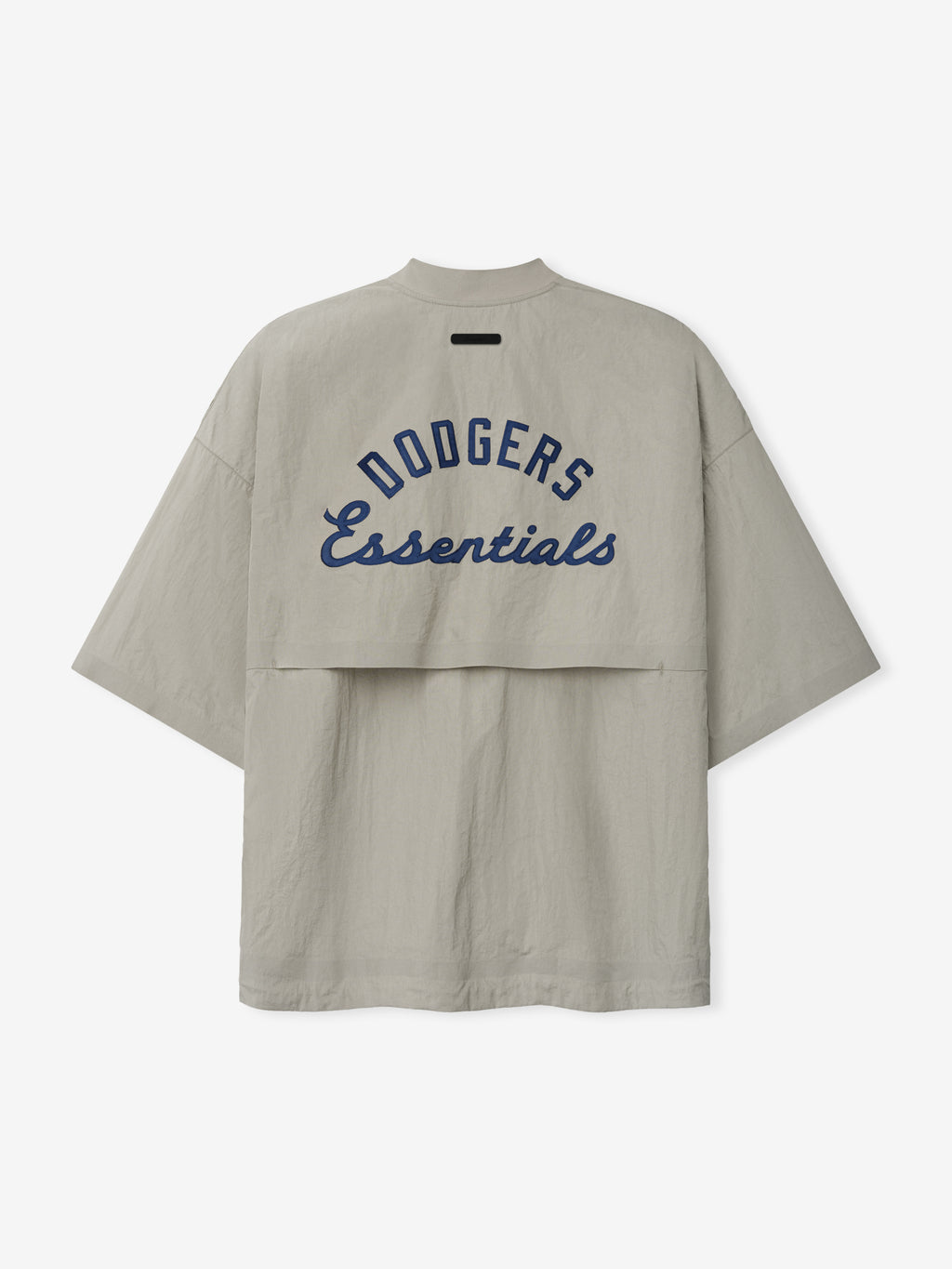 Rear view of a light taupe Dodger 3/4 Sleeve Pullover featuring navy blue "Dodgers Essentials" text across a layered back panel, with a relaxed fit and wide sleeves.