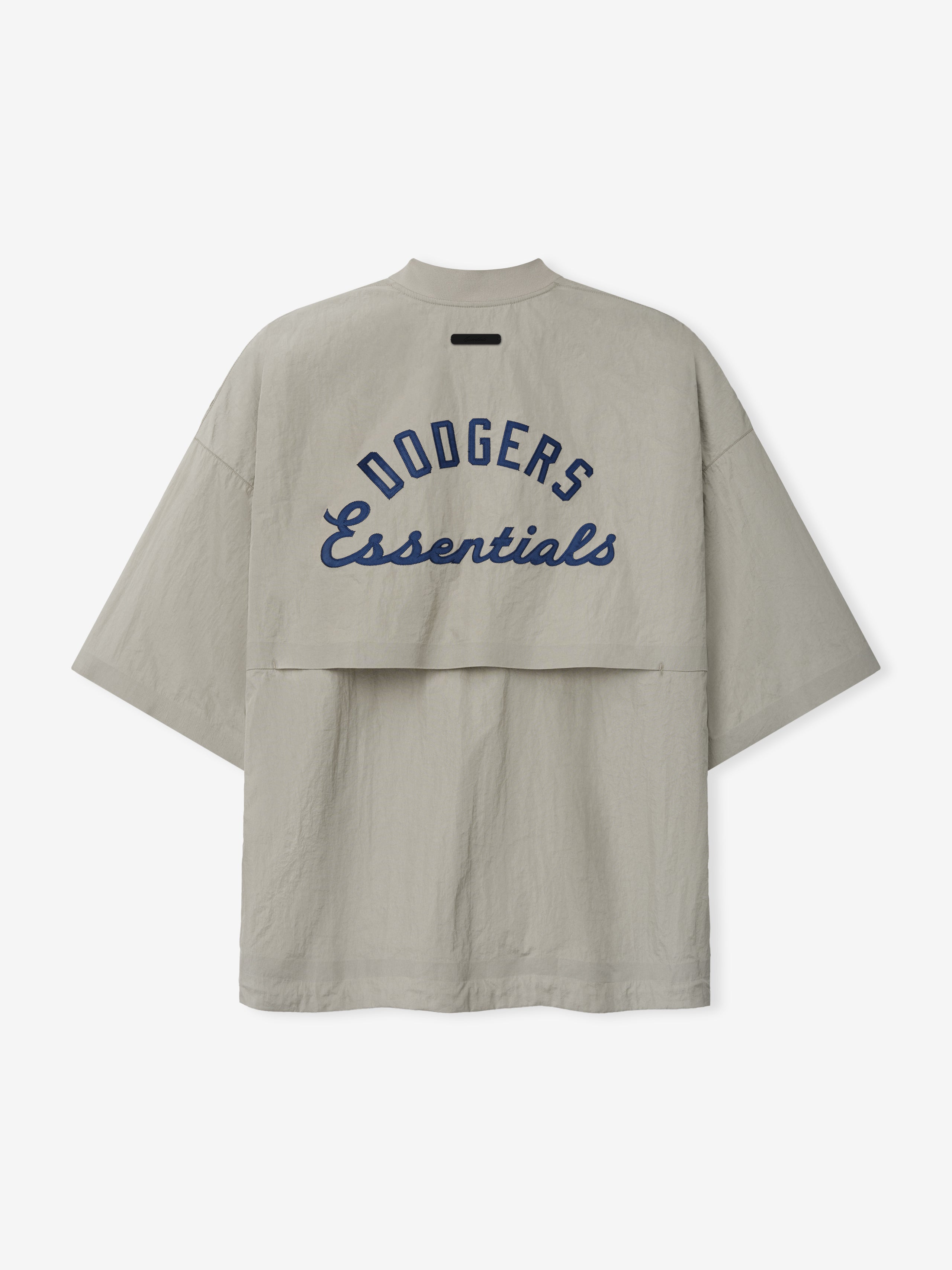 Rear view of a light taupe Dodger 3/4 Sleeve Pullover featuring navy blue "Dodgers Essentials" text across a layered back panel, with a relaxed fit and wide sleeves.
