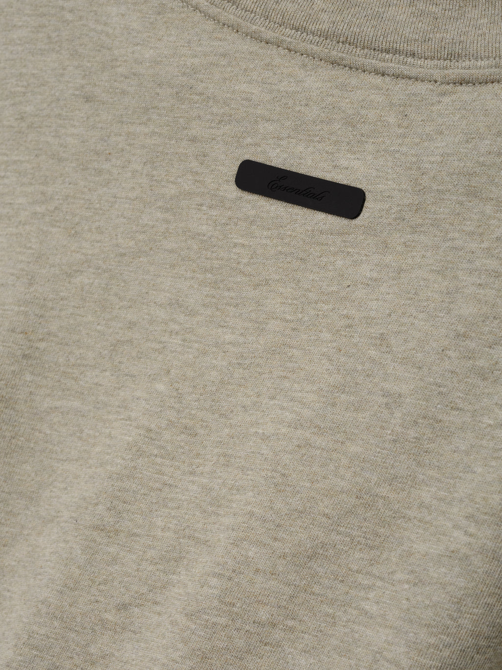Tri-Blend Essential Tee (Slim) in a soft seal heather fabric featuring a minimal black logo patch near the neckline, designed for a sleek and casual top.