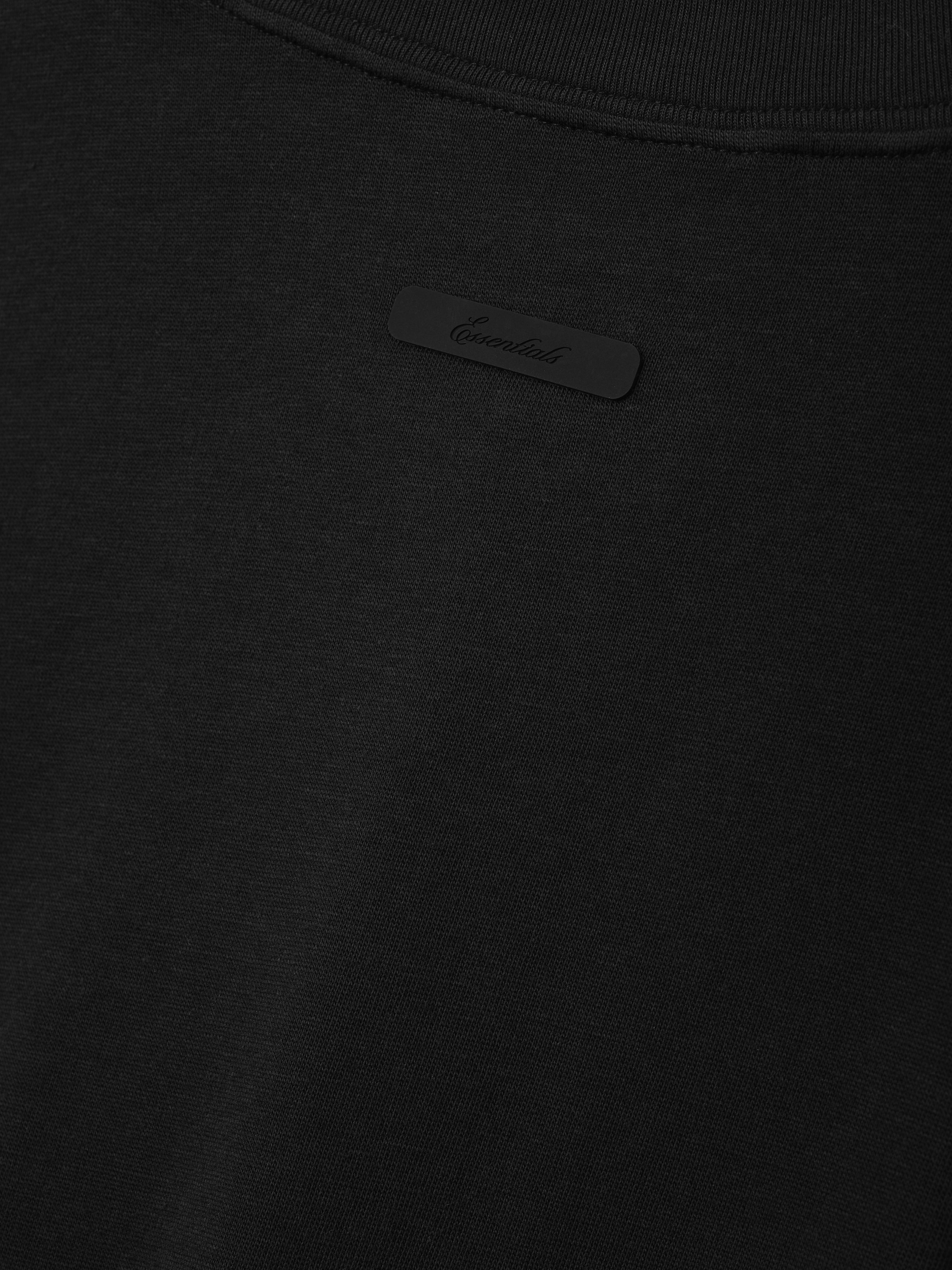 Tri-Blend Essential Tee (Slim) in a vintage black tone featuring a subtle embossed logo patch near the neckline, crafted from soft, lightweight fabric for a sleek casual top.