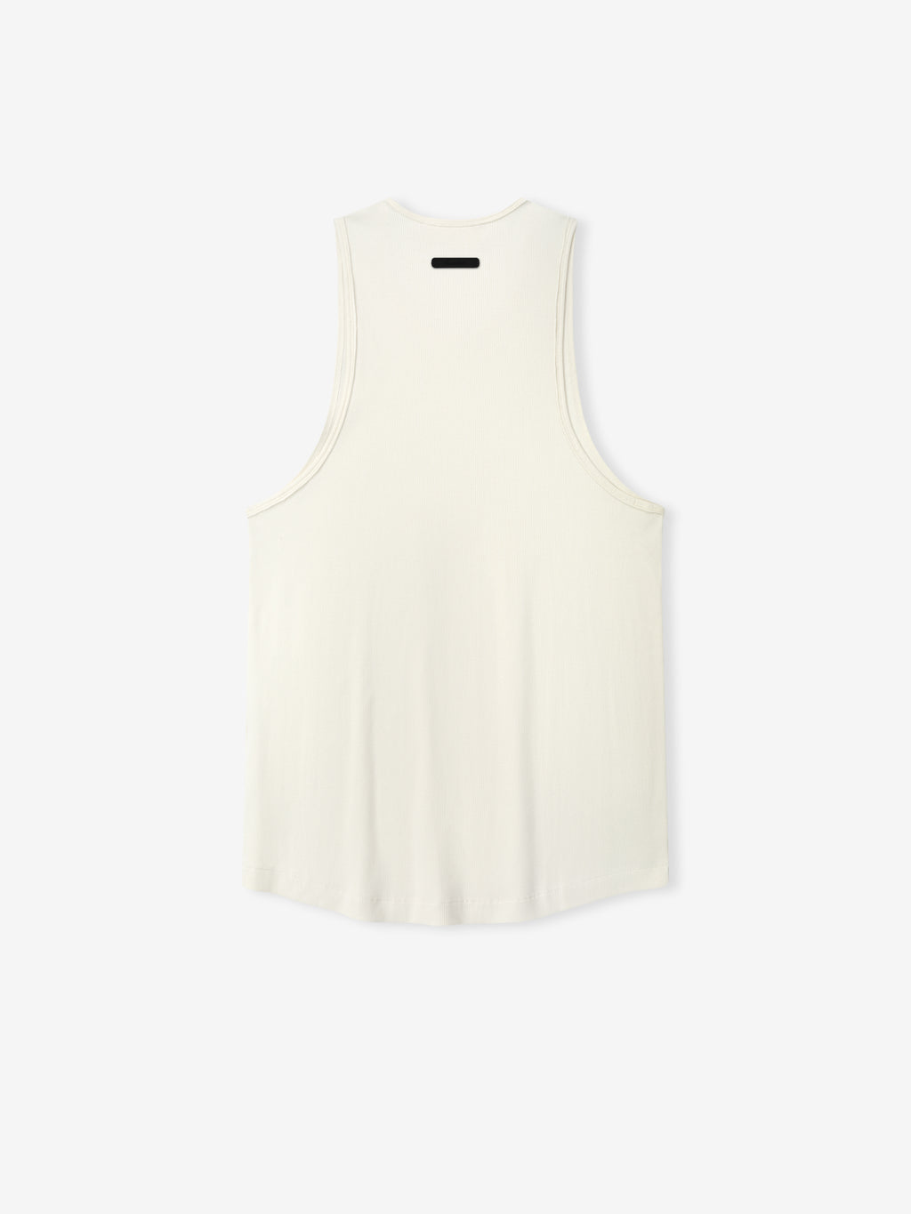 Ribbed Essential Tank in a soft ivory shade, featuring a smooth ribbed fabric with a relaxed cut and wide armholes for comfortable casual layering tops.