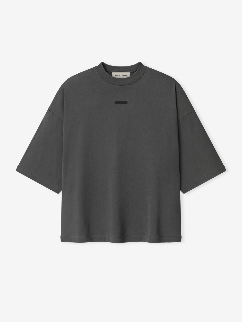 Merch Tee (Boxy) in muted iron grey featuring a relaxed boxy fit with dropped shoulders and a subtle tonal rectangular detail at the chest for a minimalist modern top.