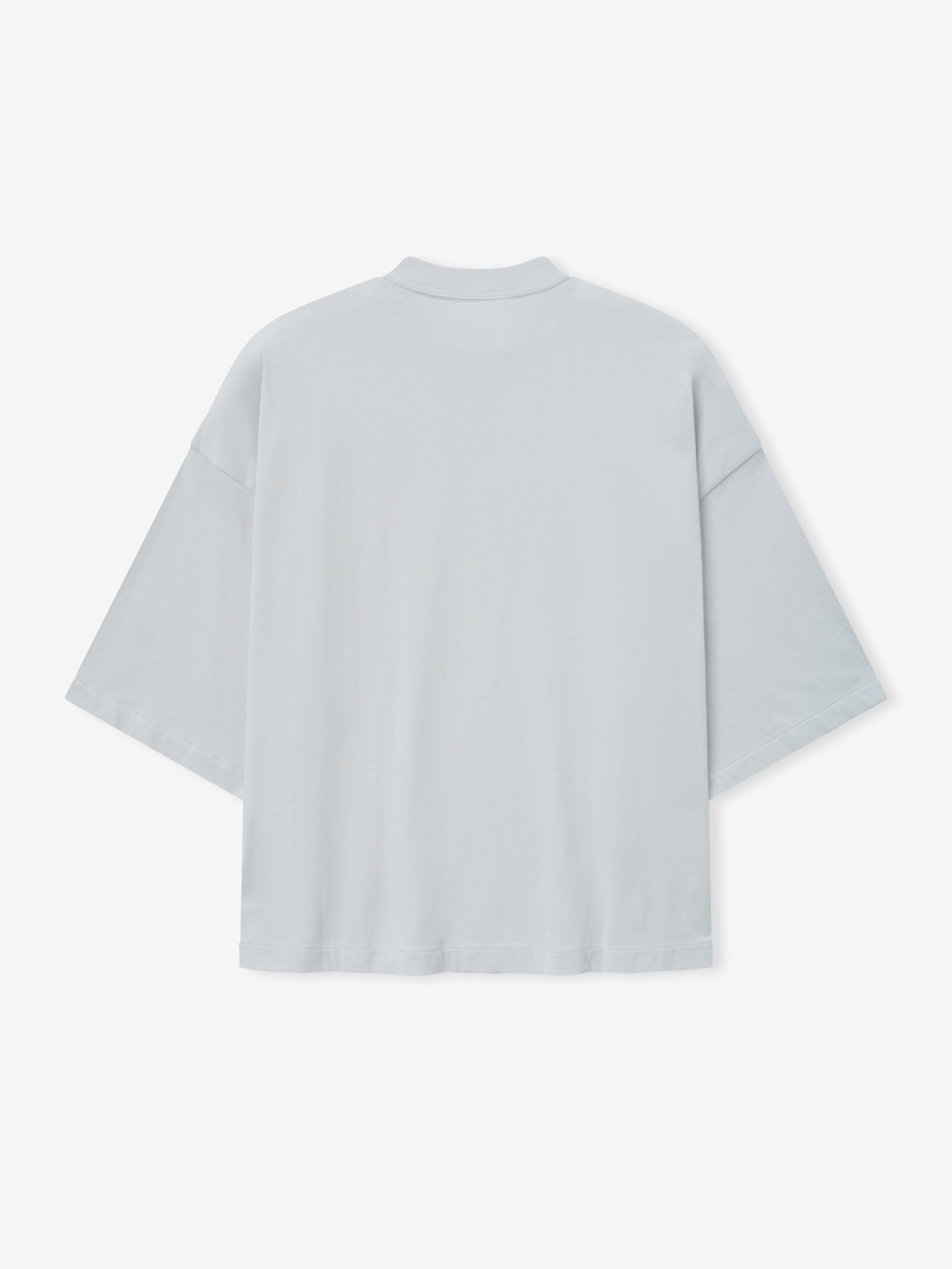 Merch Tee (Boxy) in light overcast grey featuring a loose boxy cut with dropped shoulders, short sleeves, and a smooth back for a modern minimalist casual top.