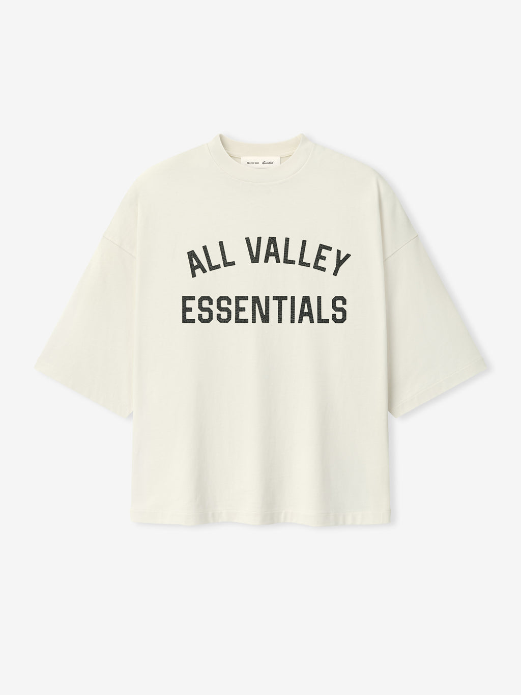 Merch Tee (Boxy) in a soft ivory shade featuring a relaxed boxy silhouette with dropped shoulders and wide short sleeves, fronted with bold black collegiate-style text for a casual top.