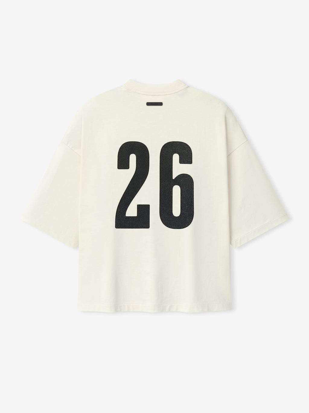 Merch Tee (Boxy) in soft ivory with an oversized boxy fit, featuring dropped shoulders, short sleeves, and bold black number 26 printed on the back for a modern casual top.