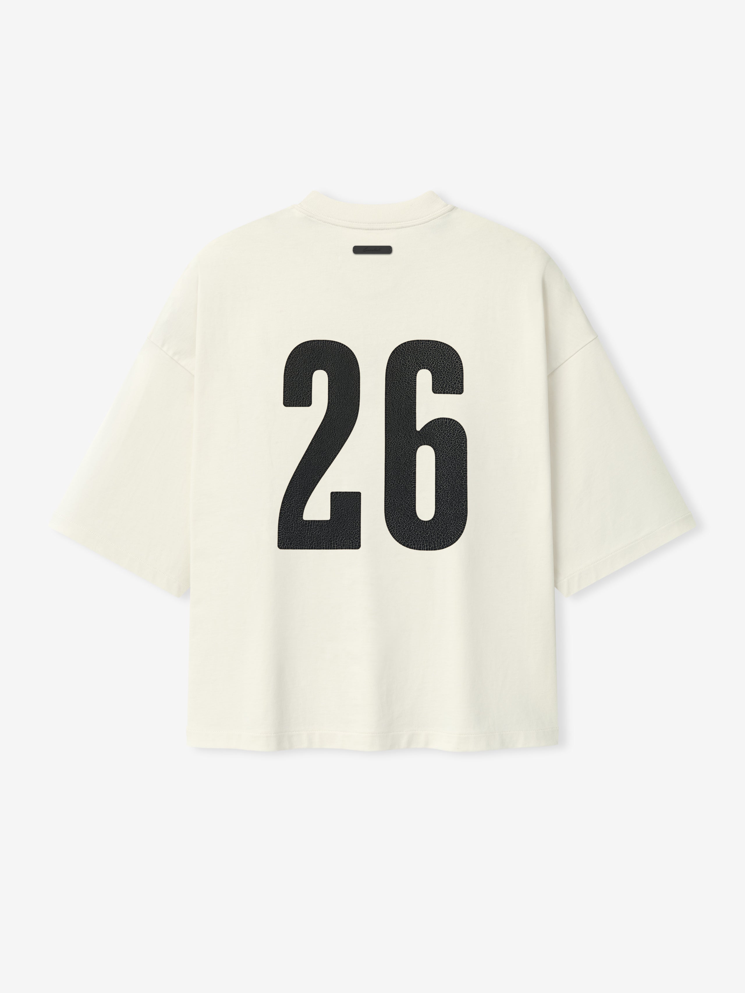 Merch Tee (Boxy) in soft ivory with an oversized boxy fit, featuring dropped shoulders, short sleeves, and bold black number 26 printed on the back for a modern casual top.