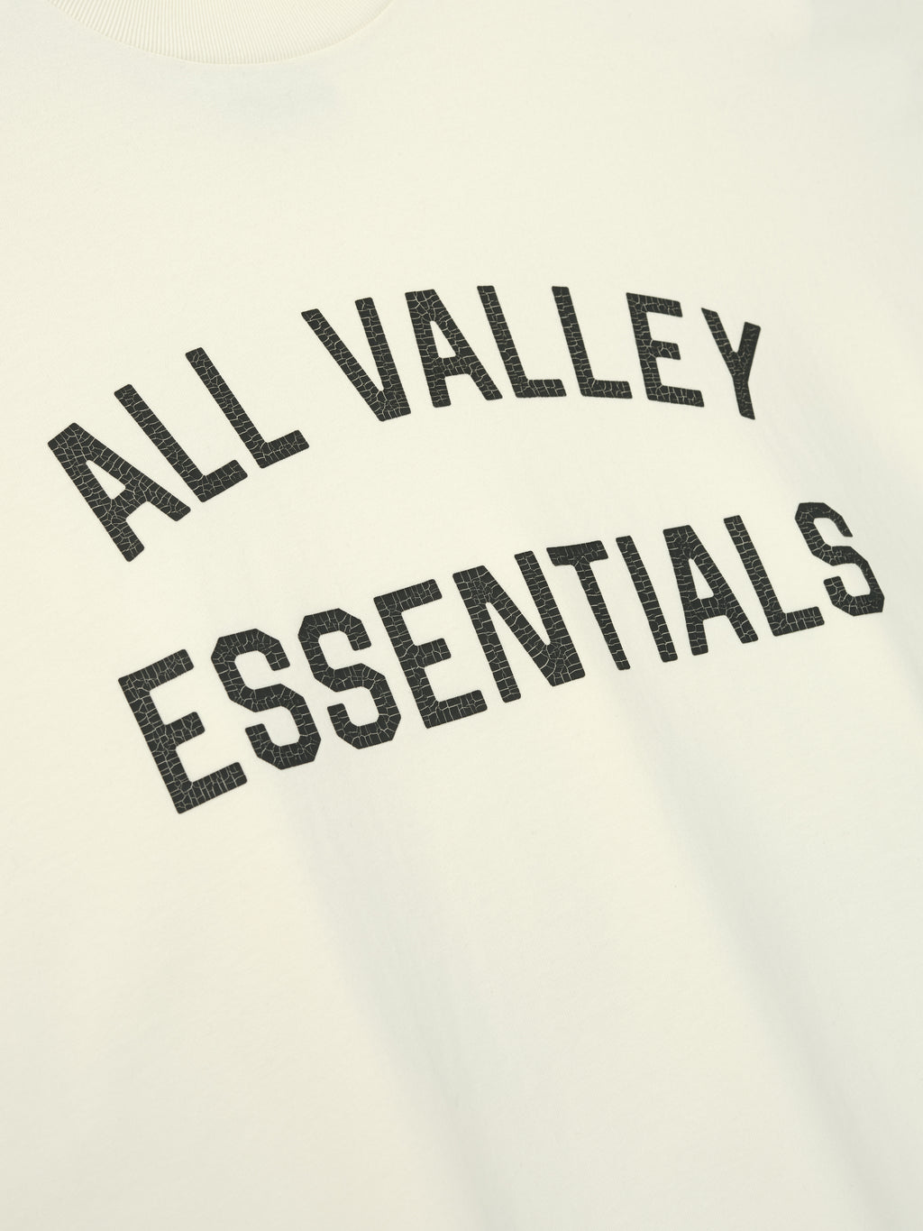 Merch Tee (Boxy) in ivory with a relaxed fit featuring bold black all valley essentials text printed across the chest for a clean, casual top.