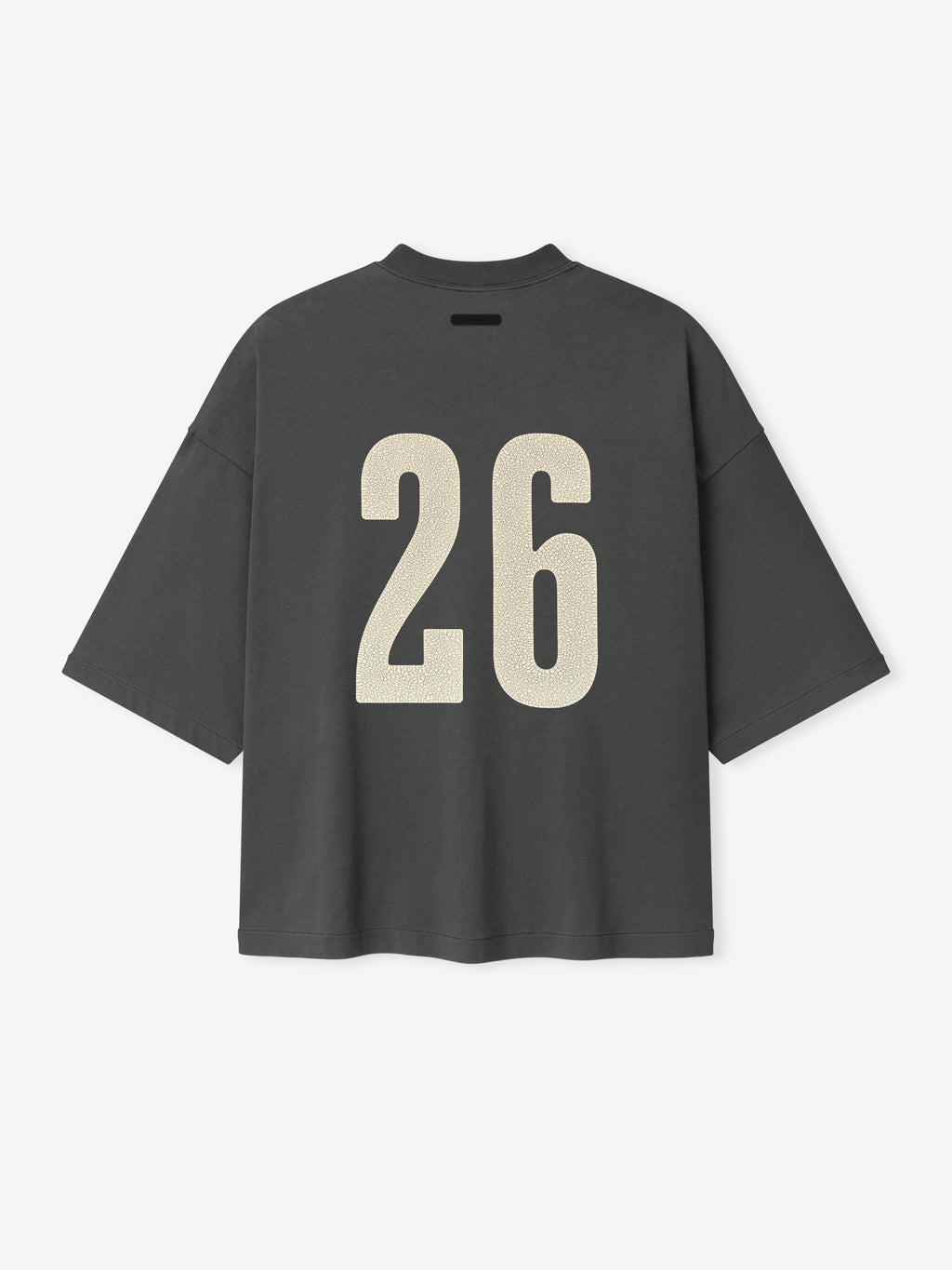 Merch Tee (Boxy) in dark iron grey with an oversized fit, dropped shoulders, and wide half sleeves, featuring a bold cream number 26 printed on the back for a sporty look.