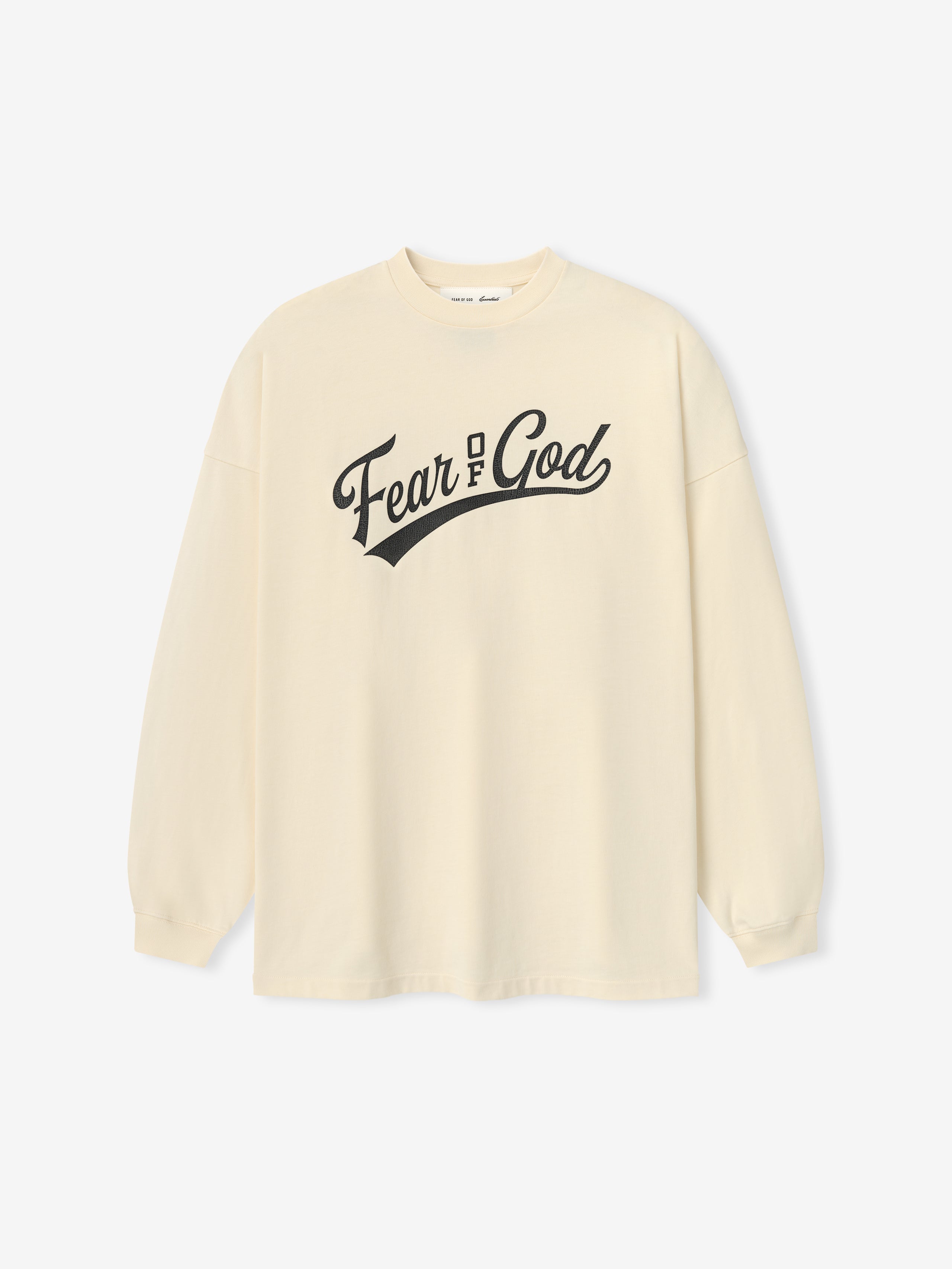 Merch Long Sleeve Tee in a soft chalk color featuring a classic crew neckline and long sleeves, with a bold black "Fear of God" graphic across the chest for a minimalist look.