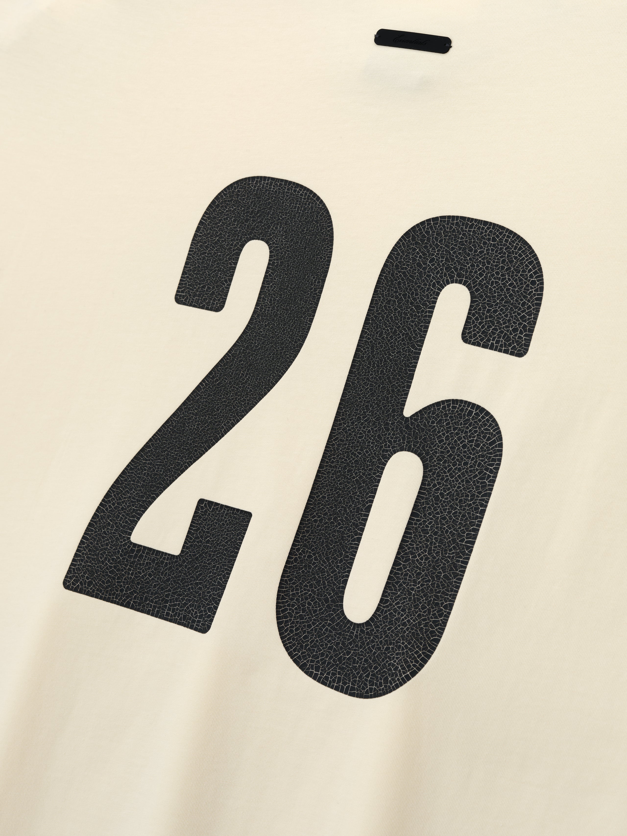 Merch Long Sleeve Tee in a soft chalk color featuring a large textured black number "26" printed on the back for a bold, sporty detail on this casual top.