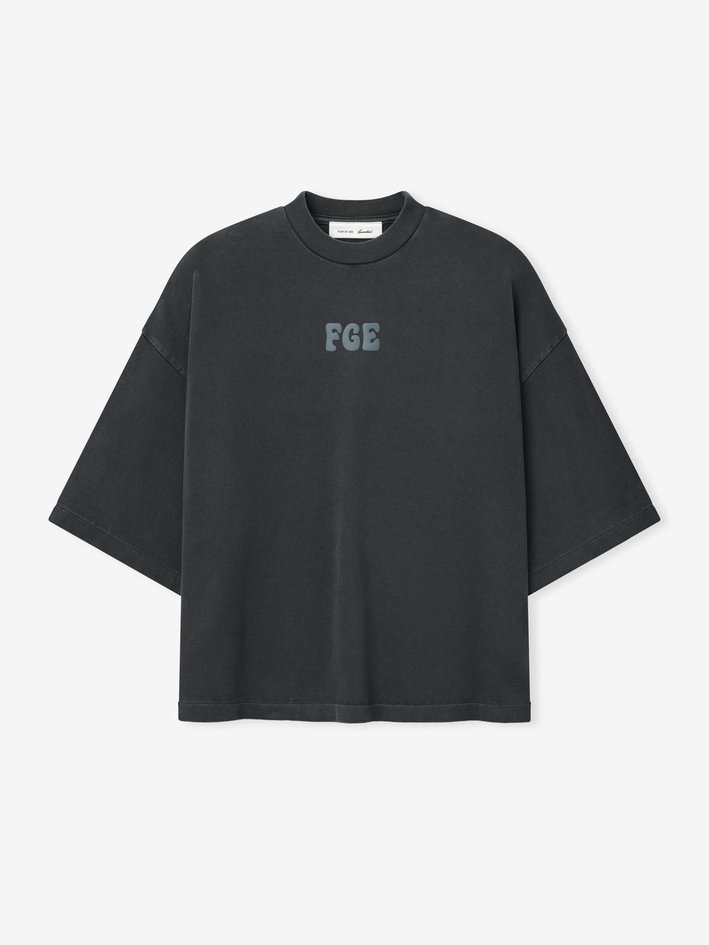 Heavy Jersey Merch Tee in a washed iron grey tone with a relaxed oversized fit, featuring a small textured "FGE" logo centered on the chest for a minimalist casual top.