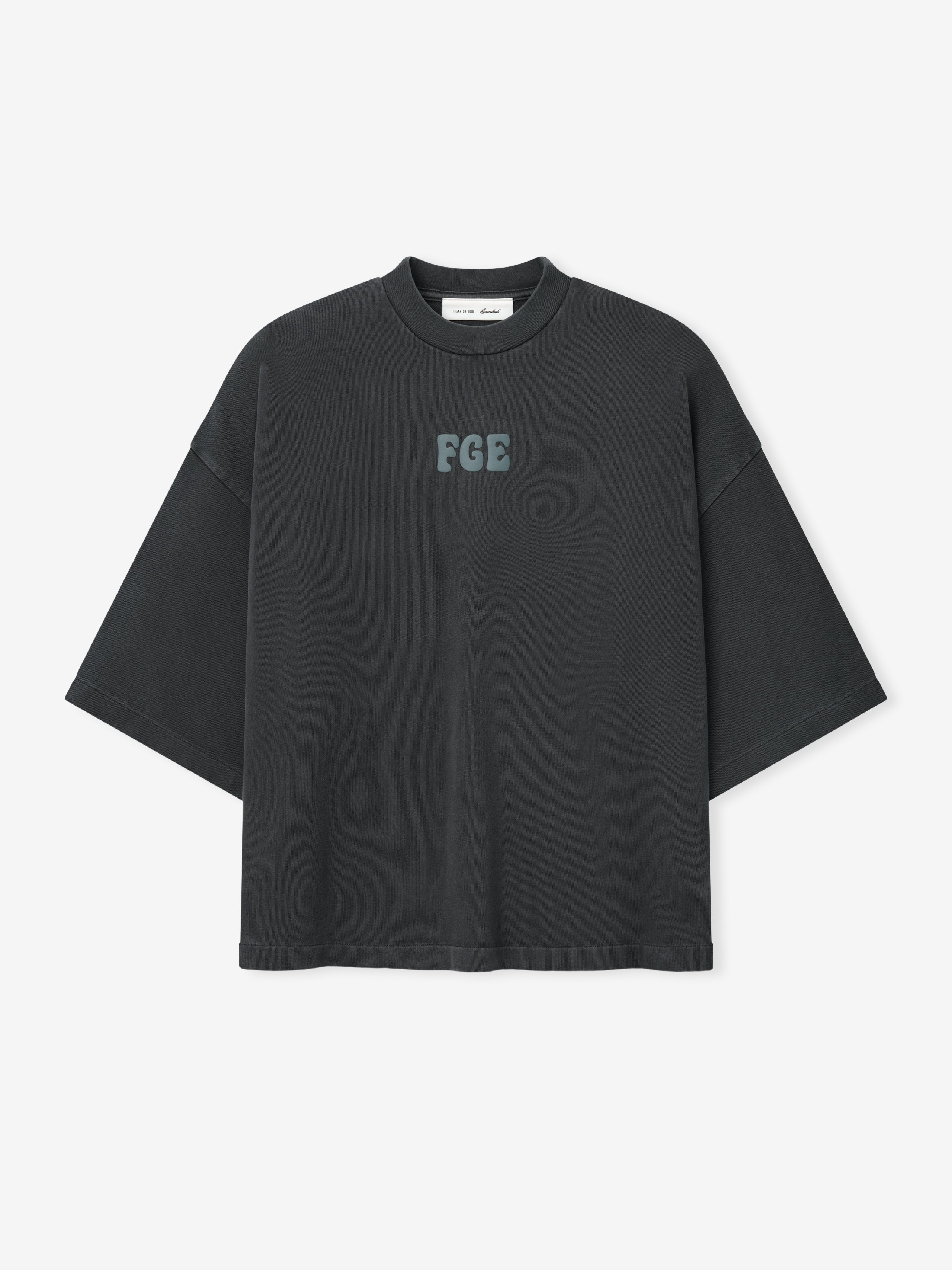 Heavy Jersey Merch Tee in a washed iron grey tone with a relaxed oversized fit, featuring a small textured "FGE" logo centered on the chest for a minimalist casual top.