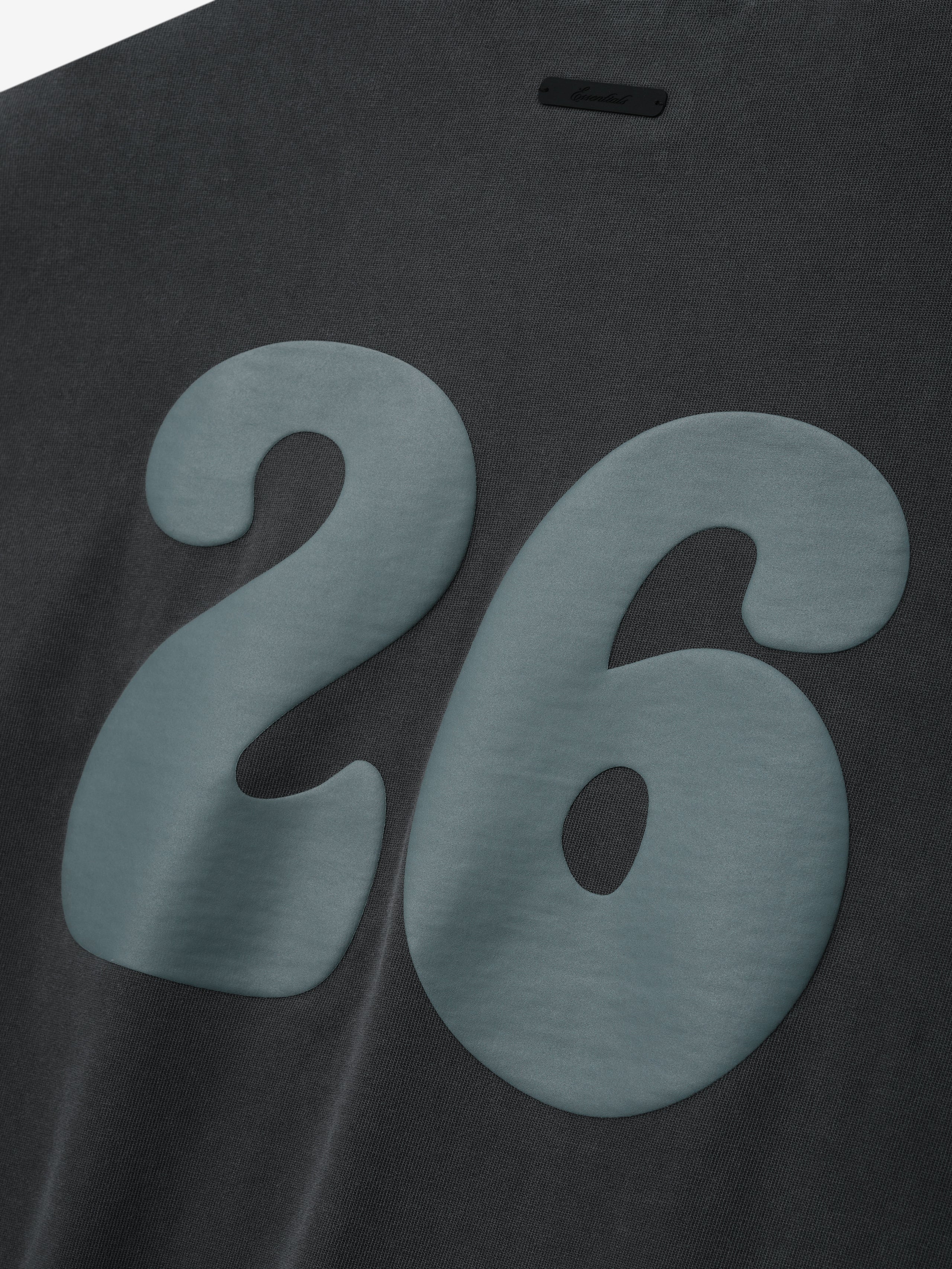 Heavy Jersey Merch Tee in a muted iron grey shade featuring a large raised number 26 in blue on the back, offering a vintage-inspired casual top with subtle texture and depth.