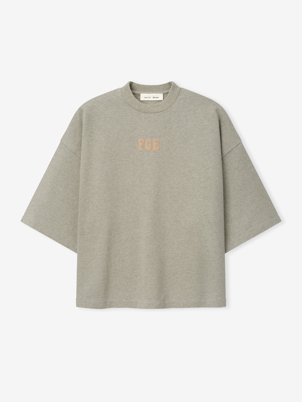 Heavy Jersey Merch Tee in a muted greyish seal hue with a loose, boxy silhouette and dropped shoulders, featuring subtle textured "FGE" lettering centered on the chest for minimalist casual wear.