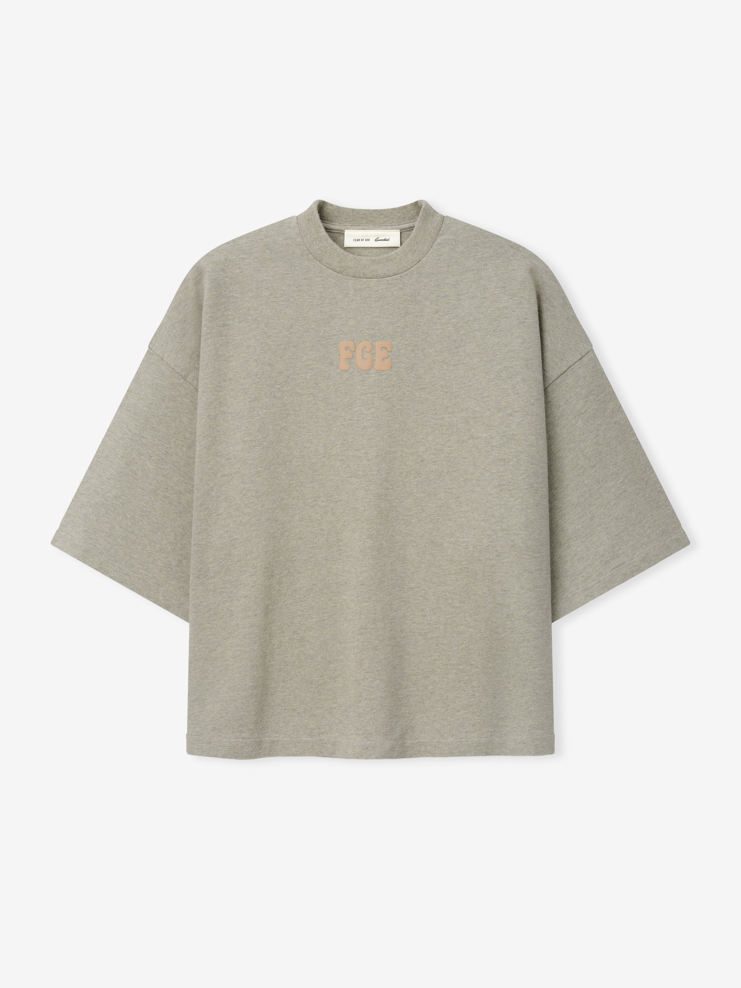 Heavy Jersey Merch Tee in a muted greyish seal hue with a loose, boxy silhouette and dropped shoulders, featuring subtle textured "FGE" lettering centered on the chest for minimalist casual wear.