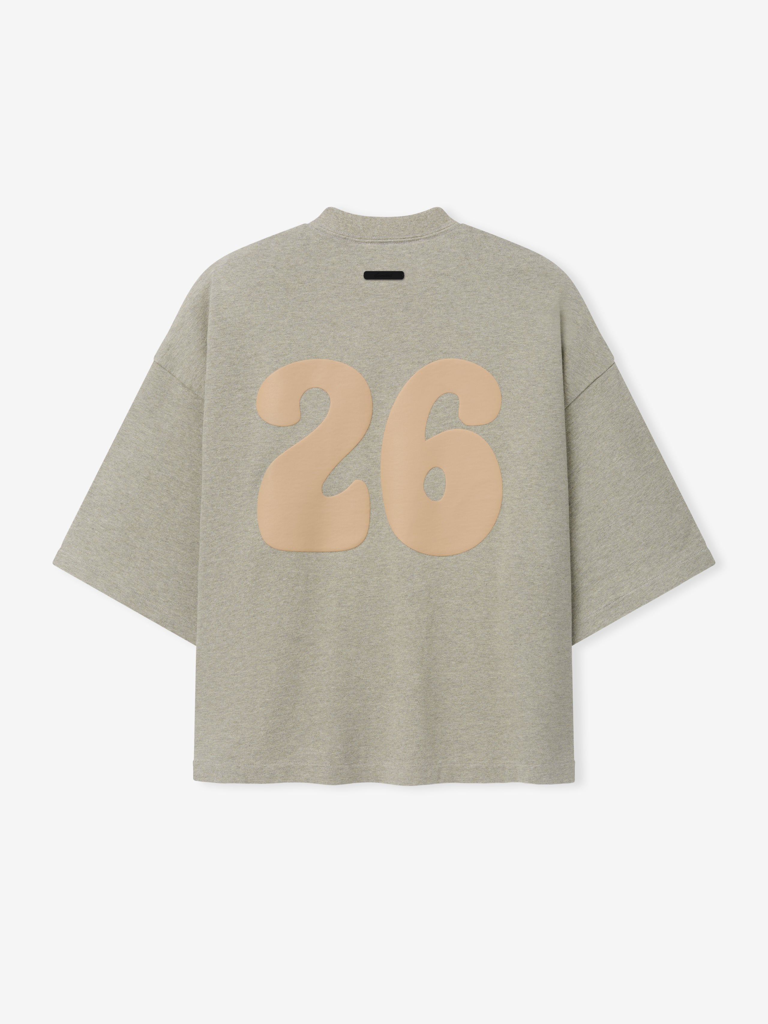 Heavy Jersey Merch Tee in a soft heathered seal tone with a roomy, boxy shape, featuring an oversized beige number 26 printed on the back for a laid-back sporty top.