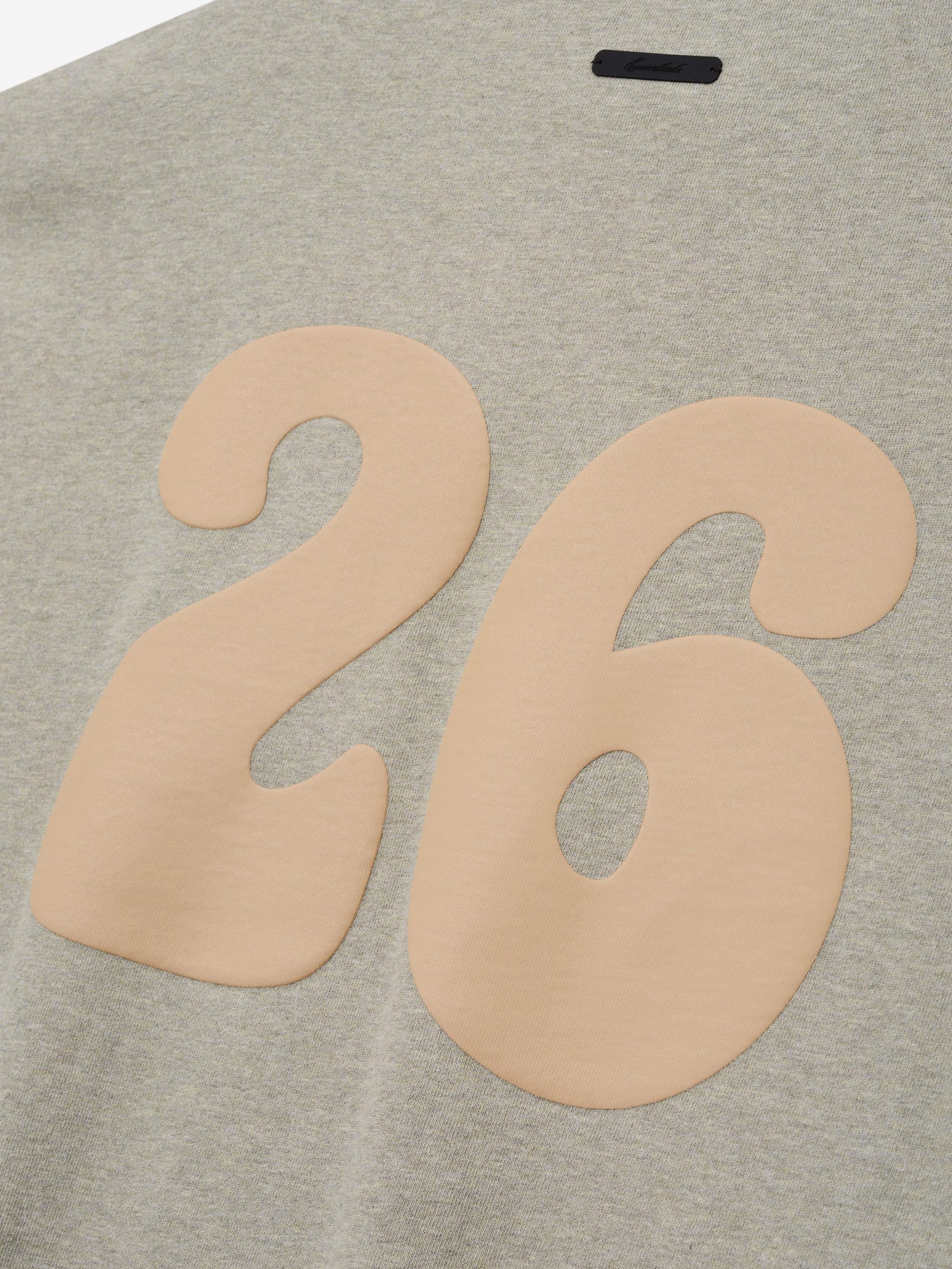 Heavy Jersey Merch Tee in a soft heathered seal tone, featuring a smooth beige number 26 printed on the back for a relaxed and stylish casual top.
