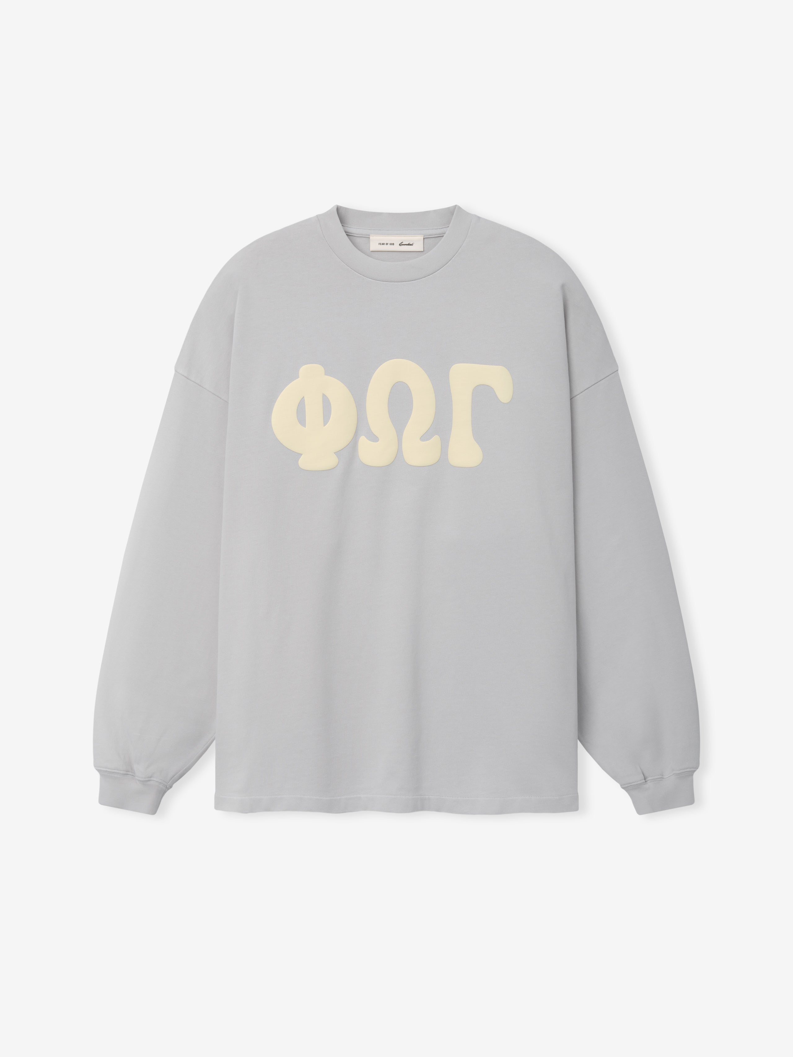 Heavy Jersey Merch Long Sleeve Tee in a soft washed overcast grey with oversized cream Greek lettering across the chest, featuring a relaxed fit and classic crew neckline.