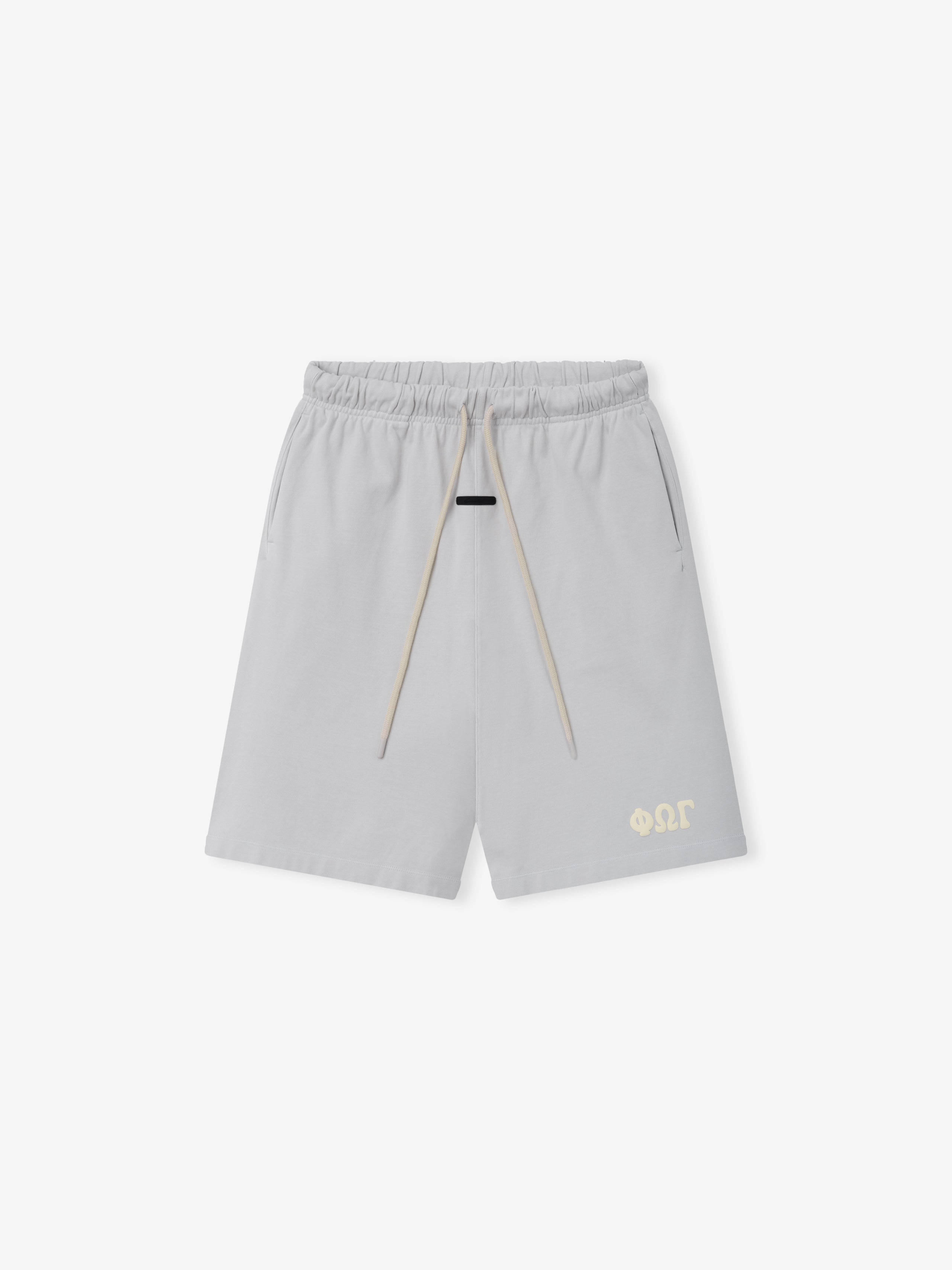 Heavy Jersey 90'S Sweatshort in a light washed iron grey with an elastic waistband, contrasting beige drawstrings, side pockets, and a small tonal logo near the hem on casual bottoms.