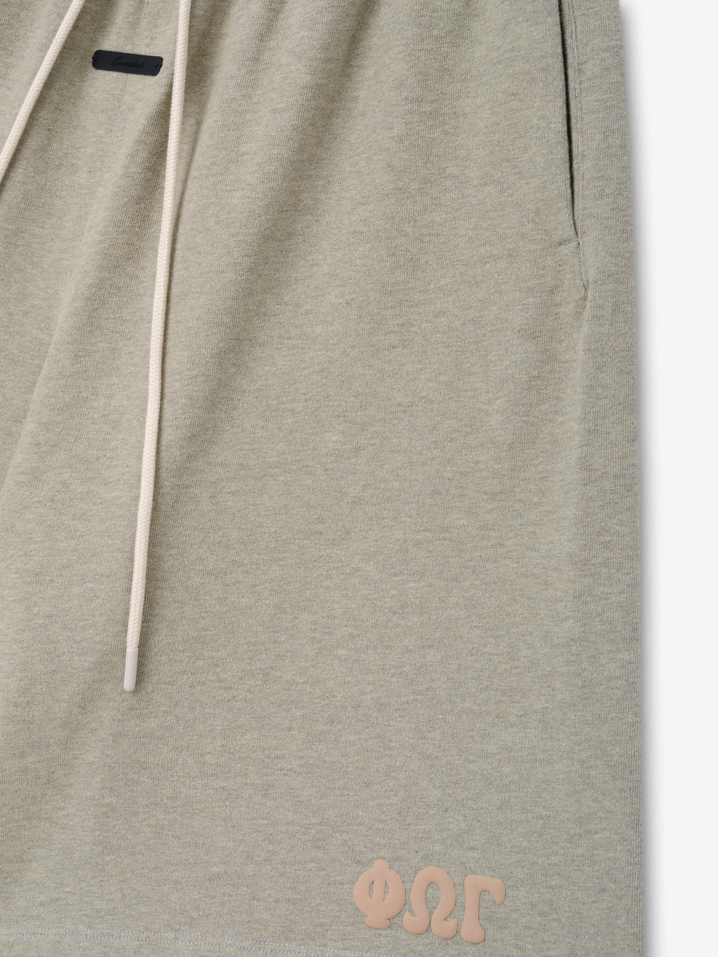 Heavy Jersey 90'S Sweatshort in a soft washed seal heather tone, featuring a relaxed fit, cream drawstrings, side pockets, and a small tonal logo near the hem on casual bottoms.