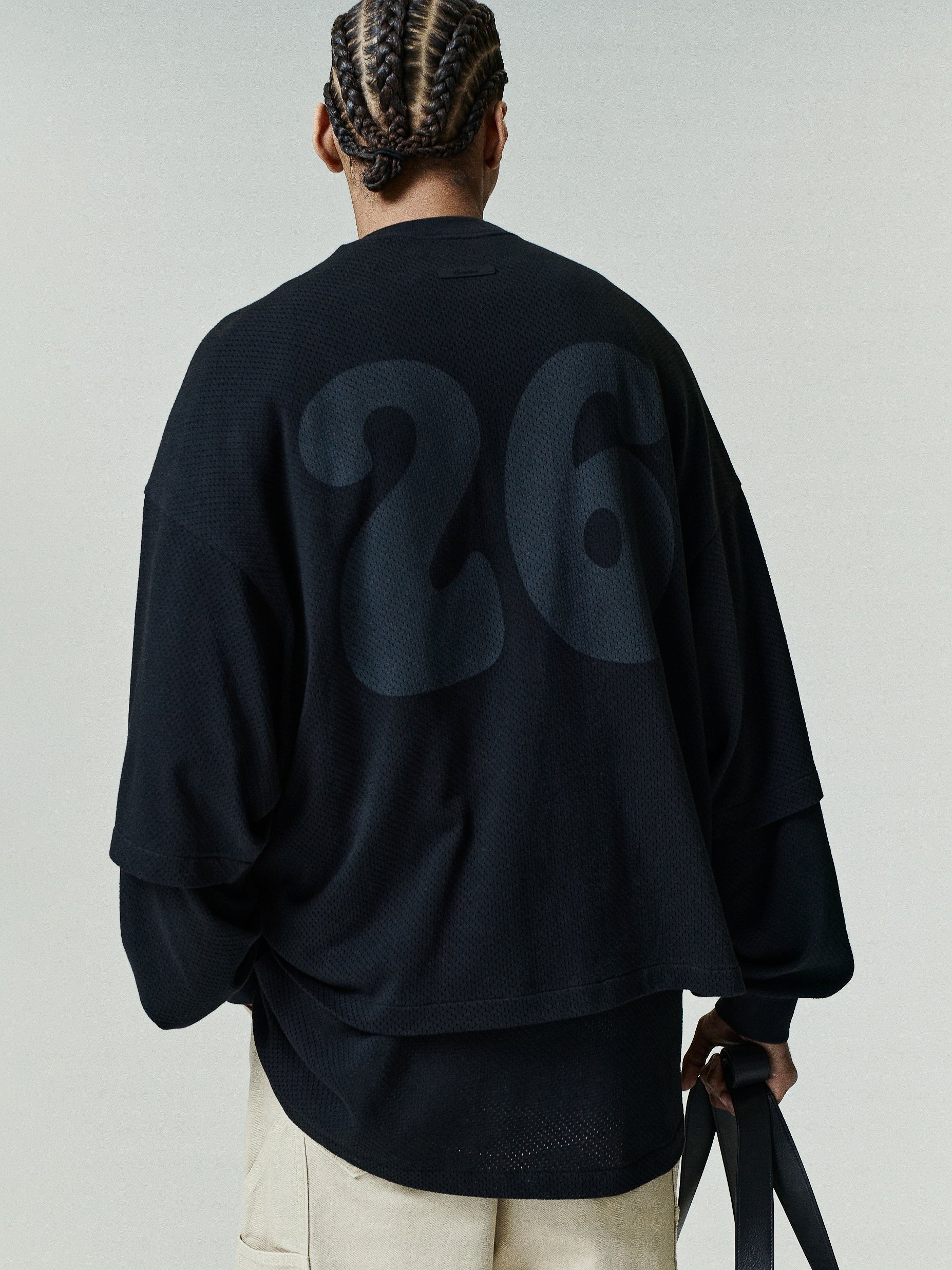 Sport Mesh Merch Tee in deep black mesh fabric with an oversized fit, featuring a subtle large number 26 printed on the back for a modern, layered sporty top.