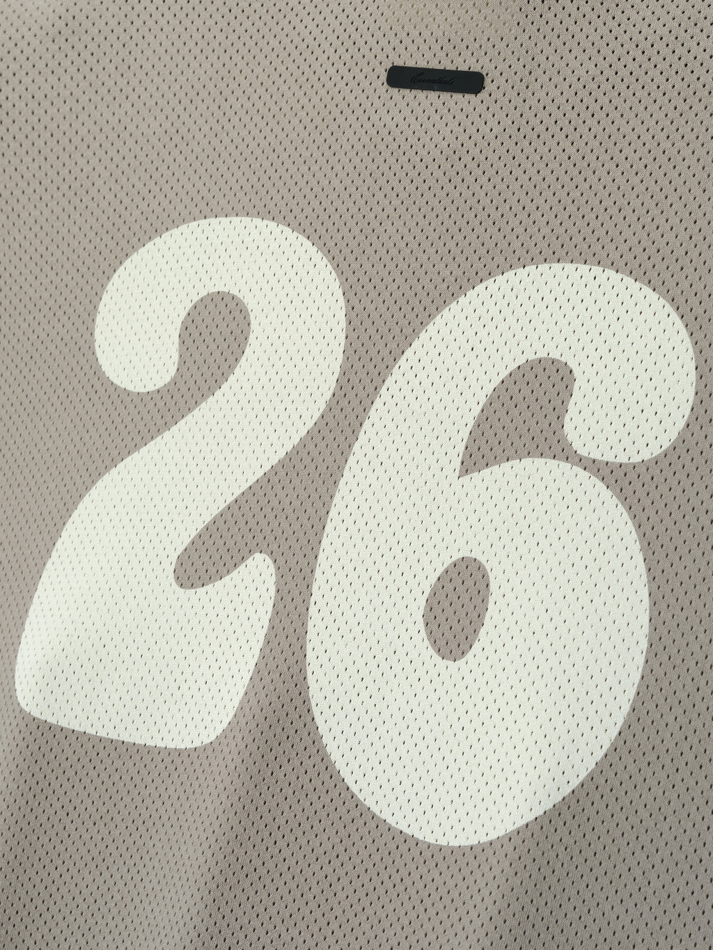 Sport Mesh Merch Tee in a muted taupe mesh fabric showcasing a large, smooth white number 26 printed prominently, offering a sporty and breathable casual top option.
