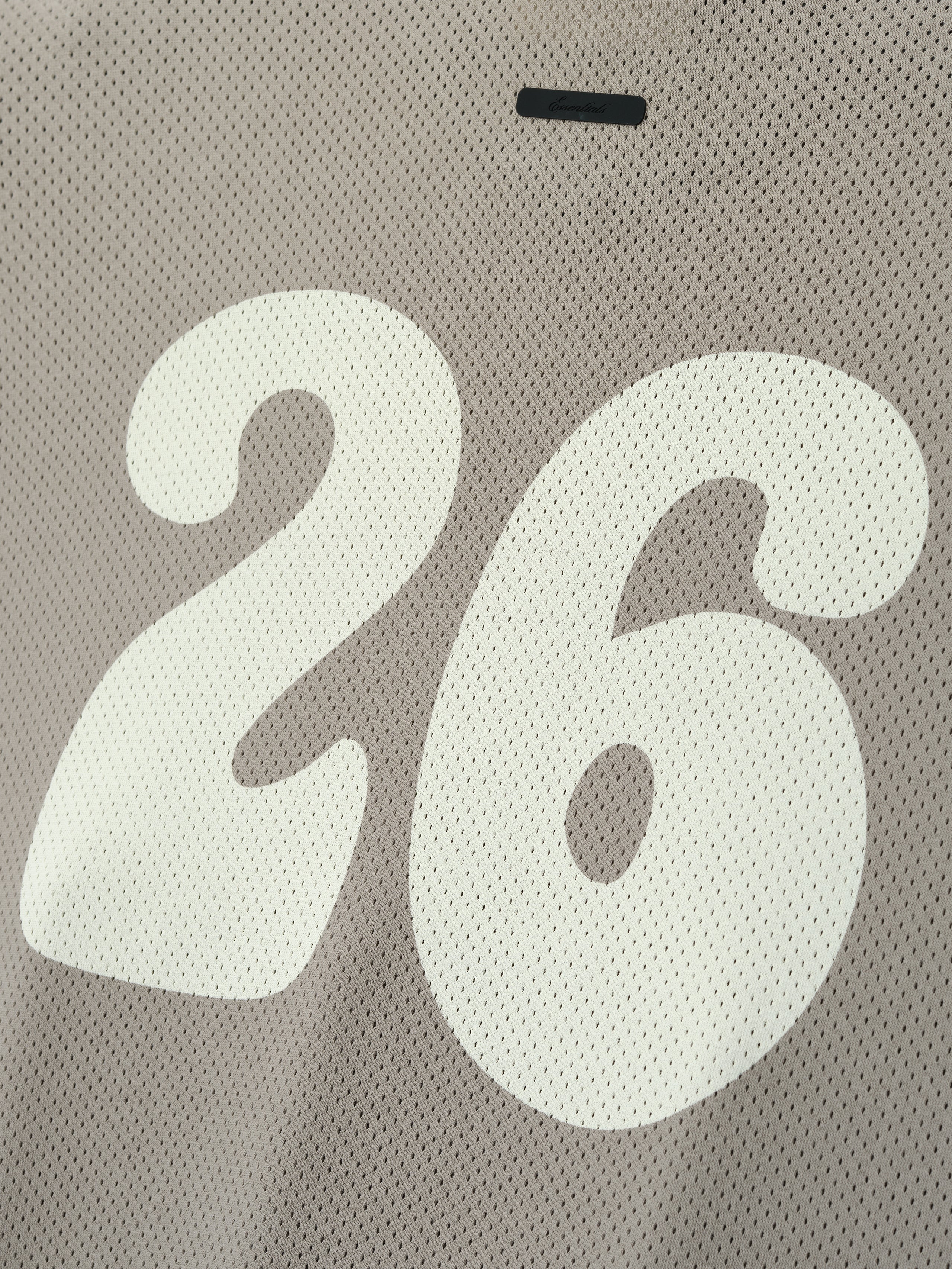 Sport Mesh Merch Tee in a muted taupe mesh fabric showcasing a large, smooth white number 26 printed prominently, offering a sporty and breathable casual top option.