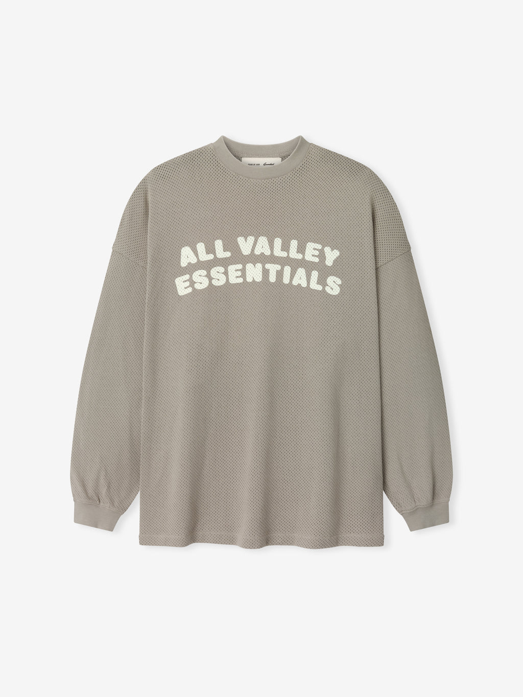 Sport Mesh Merch Long Sleeve Tee in a muted seal tone featuring a breathable textured fabric with "ALL VALLEY ESSENTIALS" printed in soft cream across the front for a casual top.