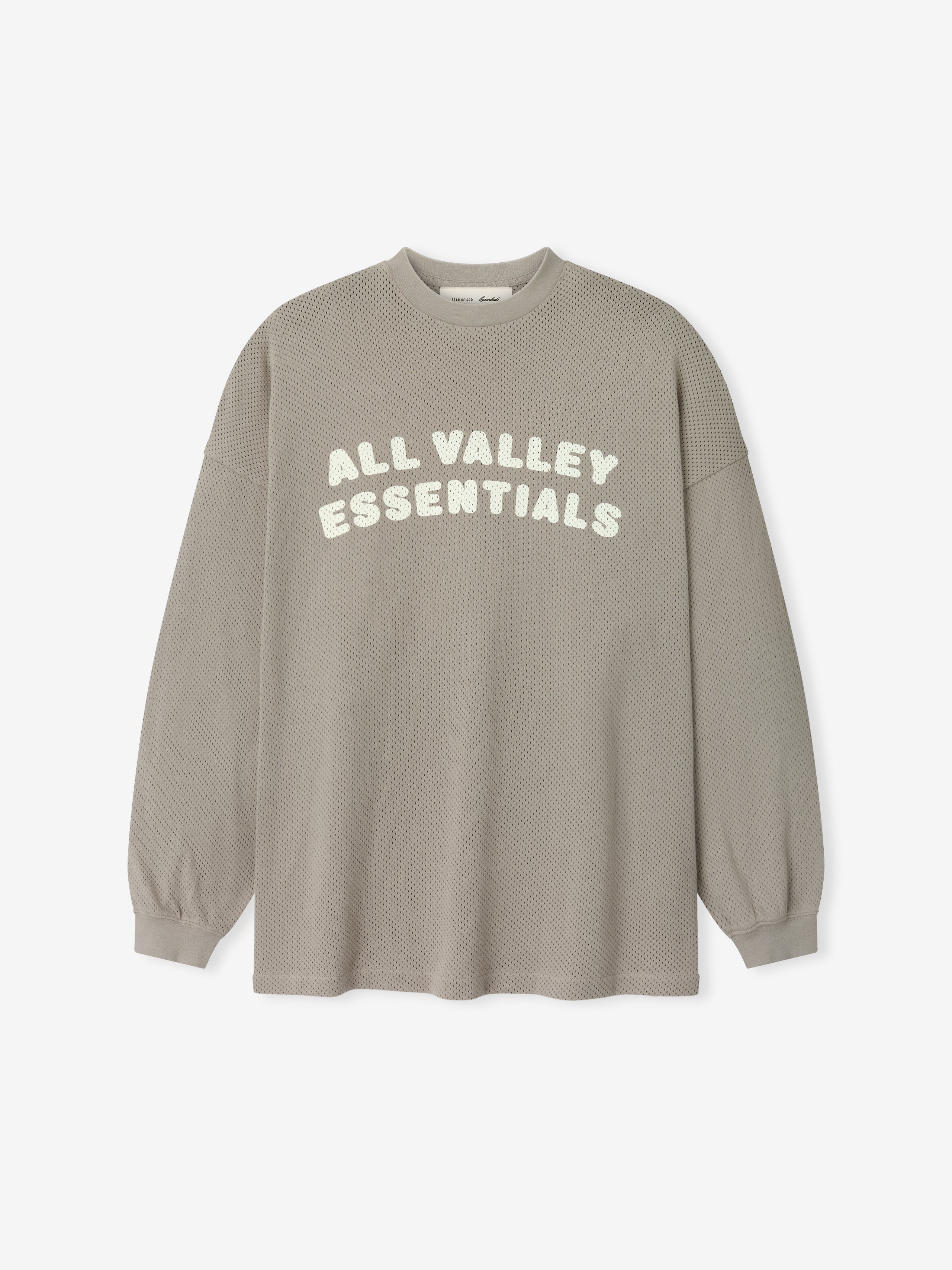Sport Mesh Merch Long Sleeve Tee in a muted seal tone featuring a breathable textured fabric with "ALL VALLEY ESSENTIALS" printed in soft cream across the front for a casual top.