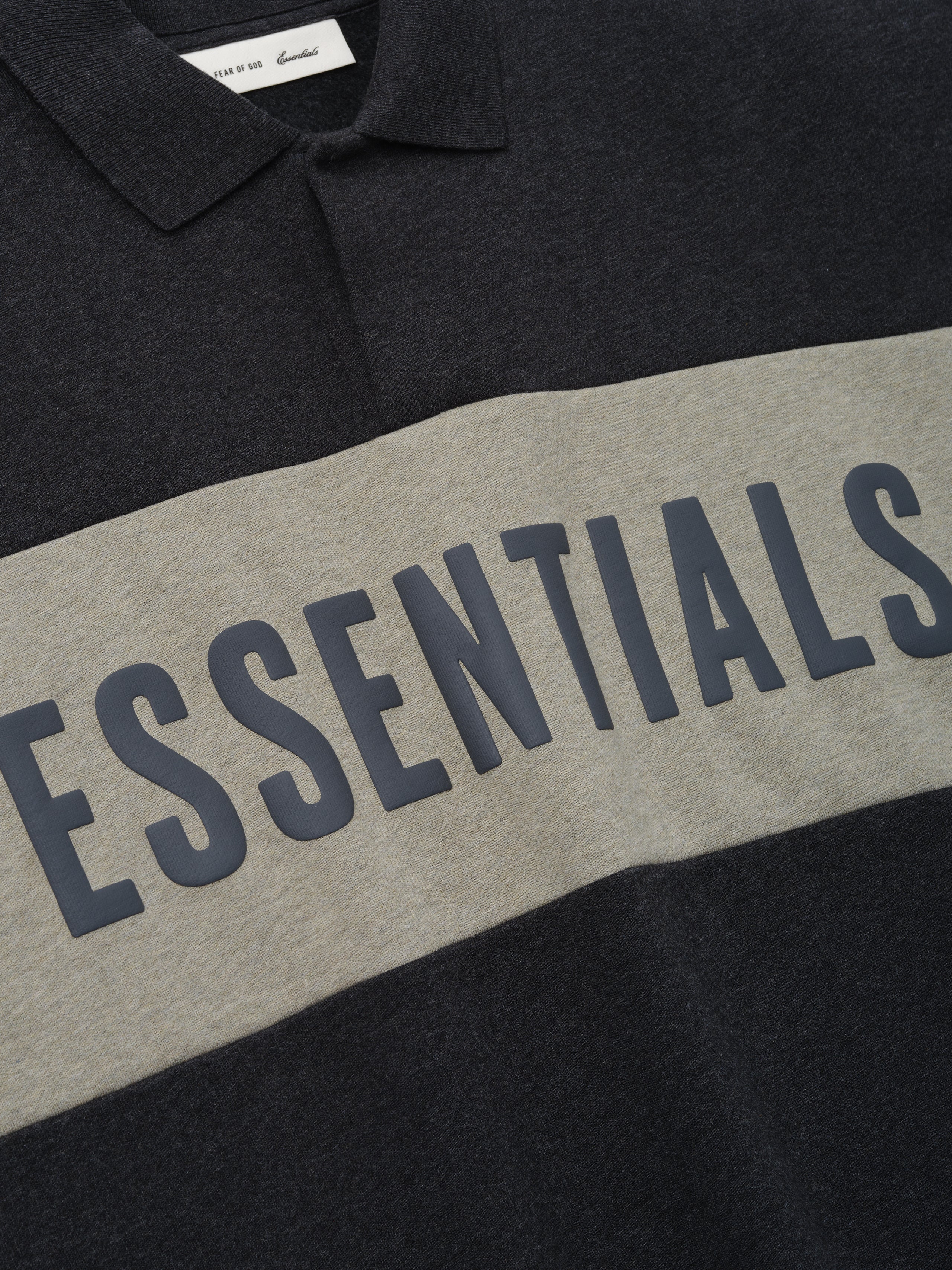 Cropped Panelled Polo in a dark heather tone with a wide contrasting panel across the chest featuring bold lettering, designed with a classic collar and soft fabric for casual tops.