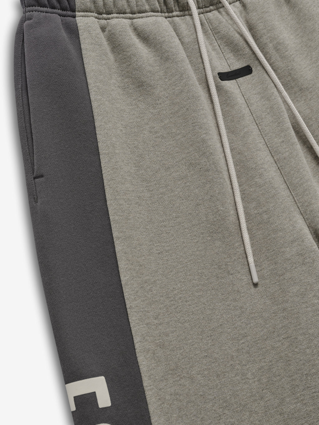 Panelled Raw Cut Off Sweatpant featuring a muted seal heather body with contrasting dark iron side panels, elastic waistband, and drawstring for casual bottoms.