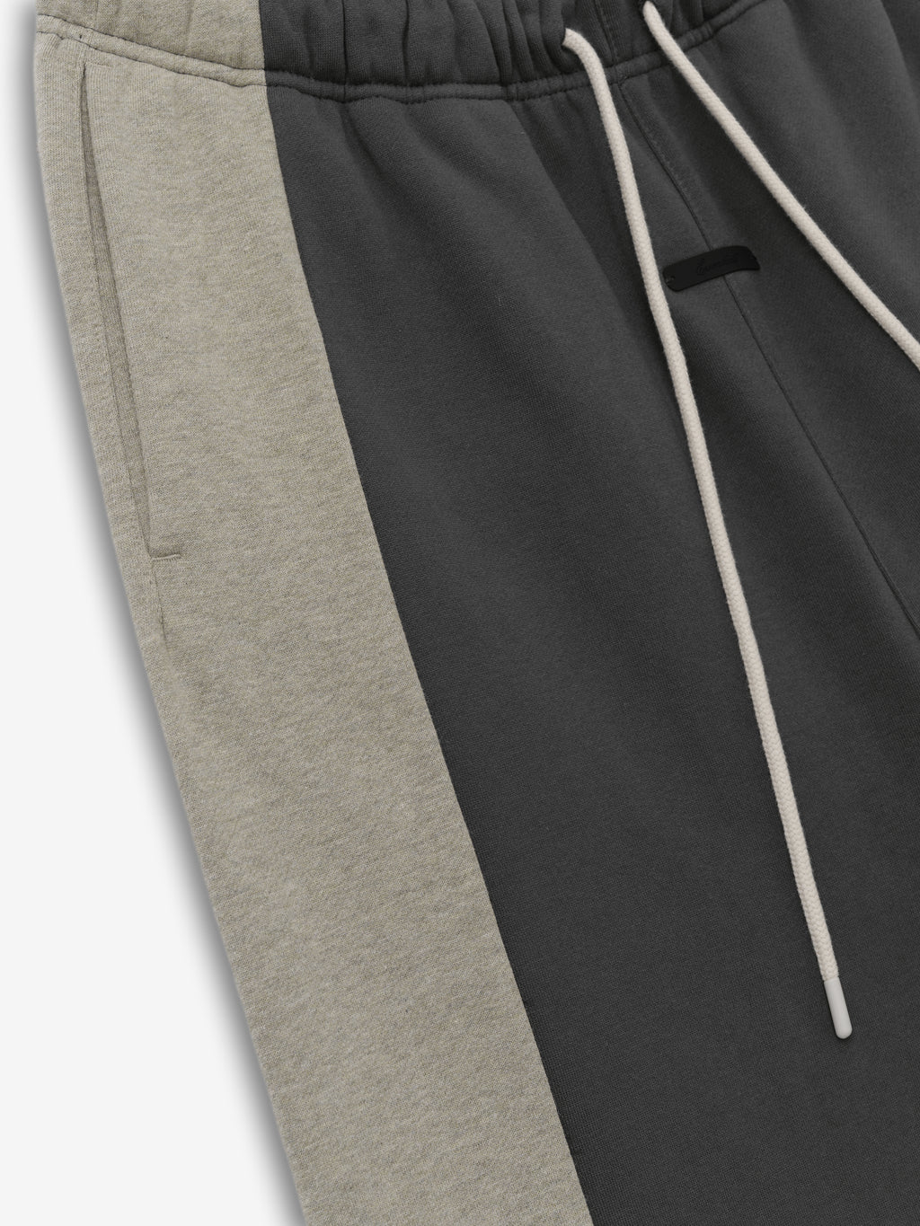 Panelled Lounge Pant showcasing a two-tone design in muted grey and dark iron shades, featuring an elastic waistband with a drawstring and side pockets for a relaxed fit bottom.