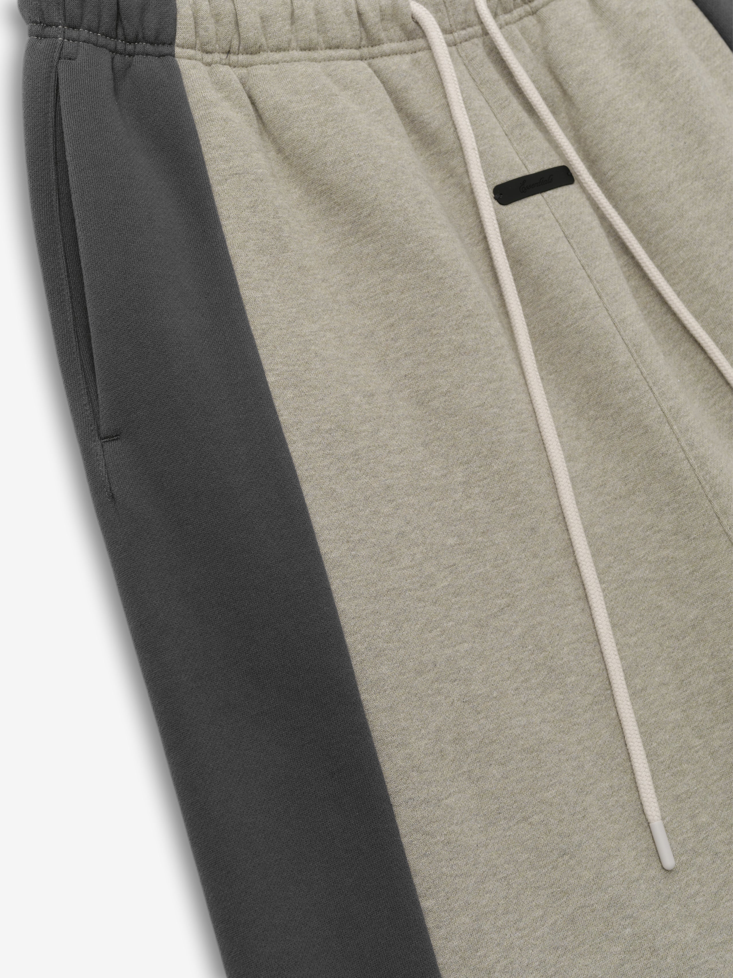Panelled Lounge Pant crafted in a soft fabric with a muted beige center and contrasting dark grey side panels, featuring an elastic waistband and adjustable drawstring for a comfortable fit.