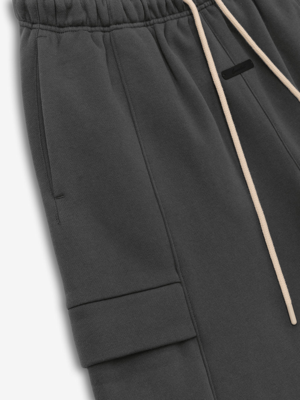 Fleece Cargo Basketball Short in dark grey with an elastic waistband, beige drawstrings, side pockets, and a cargo pocket detail for a relaxed sporty bottoms option.