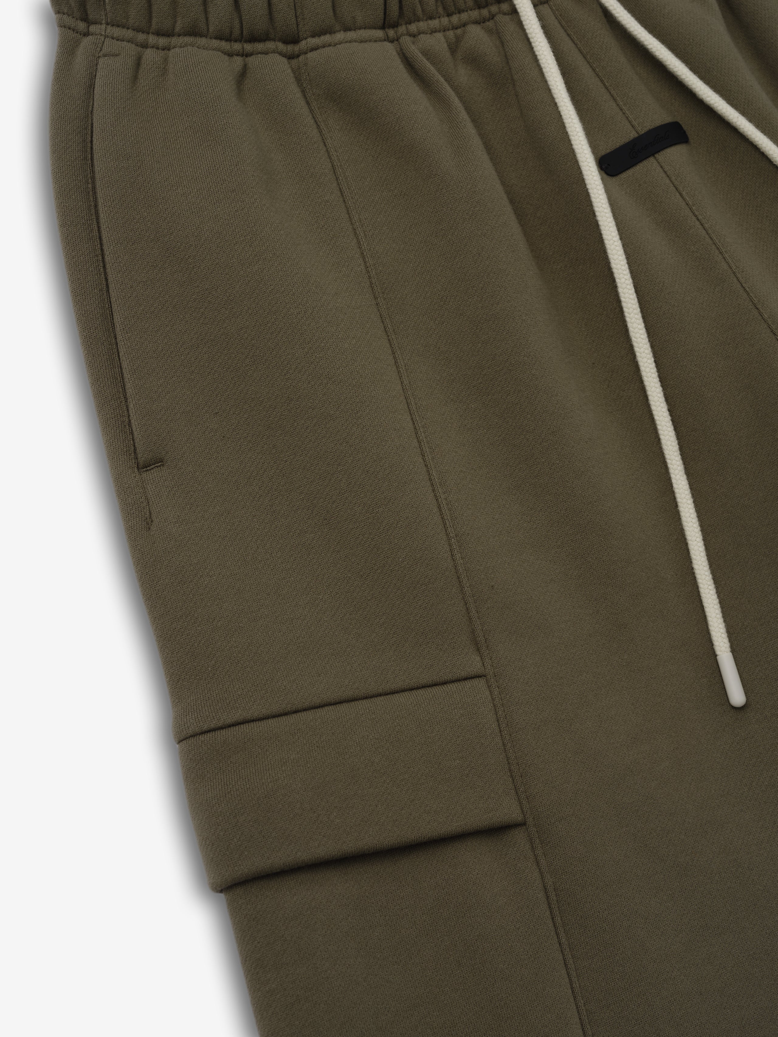 Fleece Cargo Basketball Short in deep moss green with an elastic waistband, contrasting white drawstrings, and a side flap cargo pocket for a stylish and functional bottoms choice.