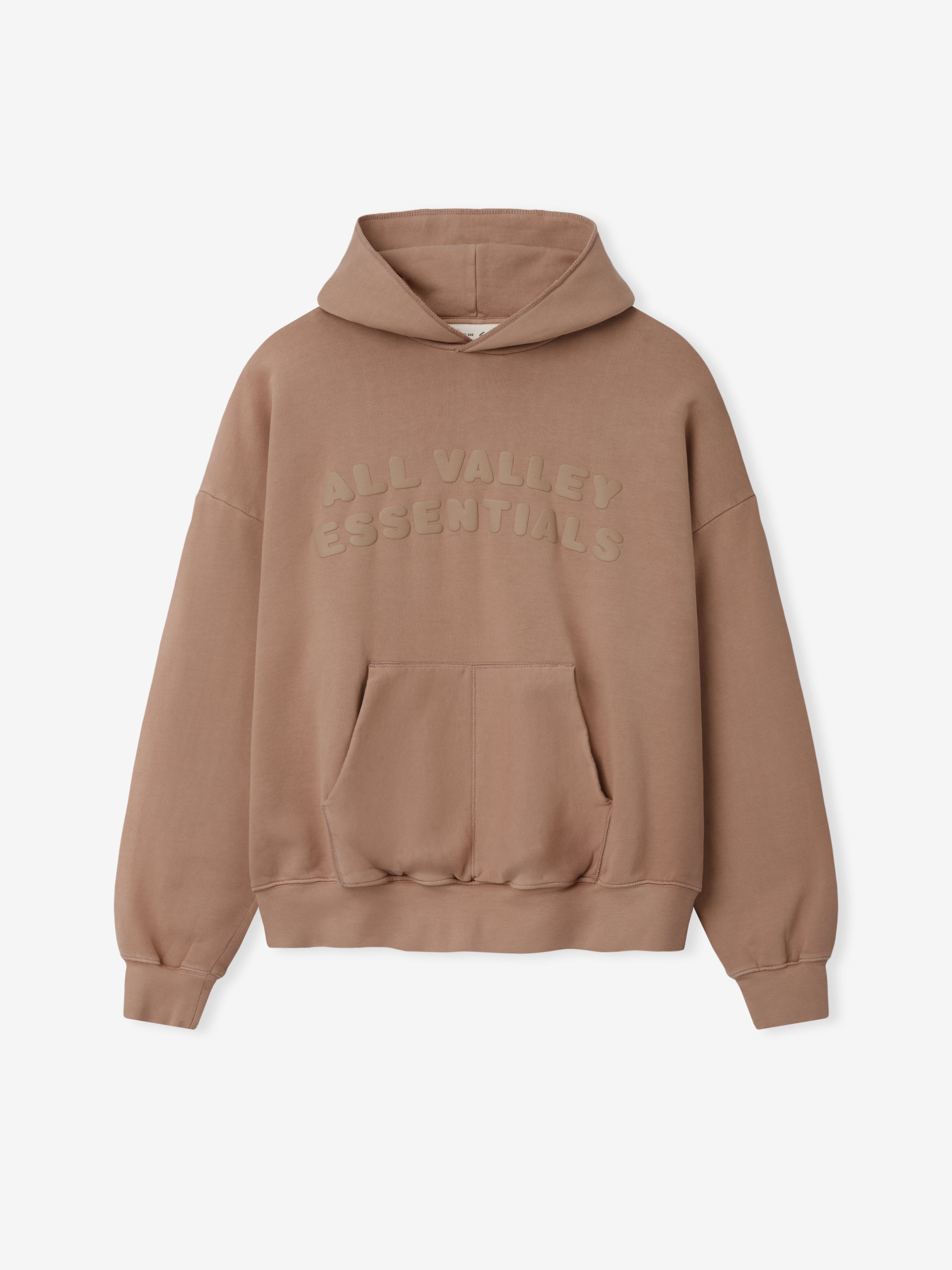 90s Hoodie in a warm washed ginger shade featuring a spacious front pocket, relaxed fit with dropped shoulders, ribbed cuffs and hem, and subtle tonal "ALL VALLEY ESSENTIALS" embroidery on the chest.