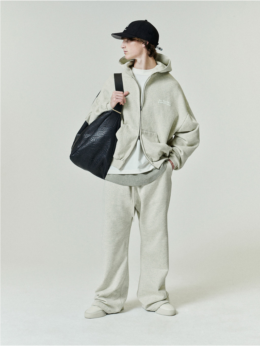 90'S Zip-Up Hoodie in a soft washed vanilla heather tone featuring an oversized fit with dropped shoulders, a front zipper, and subtle embroidered branding on the chest.