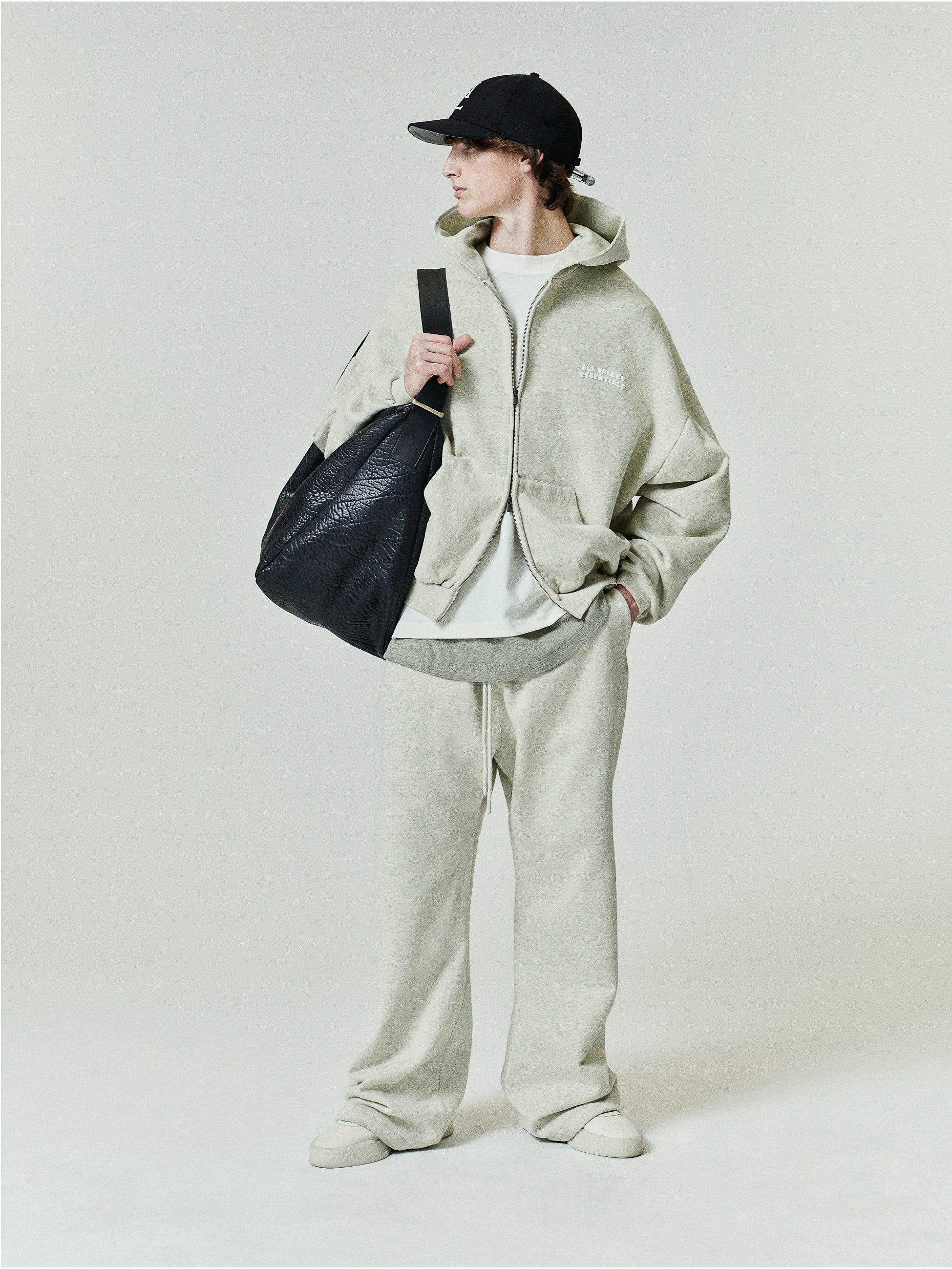90'S Zip-Up Hoodie in a soft washed vanilla heather tone featuring an oversized fit with dropped shoulders, a front zipper, and subtle embroidered branding on the chest.