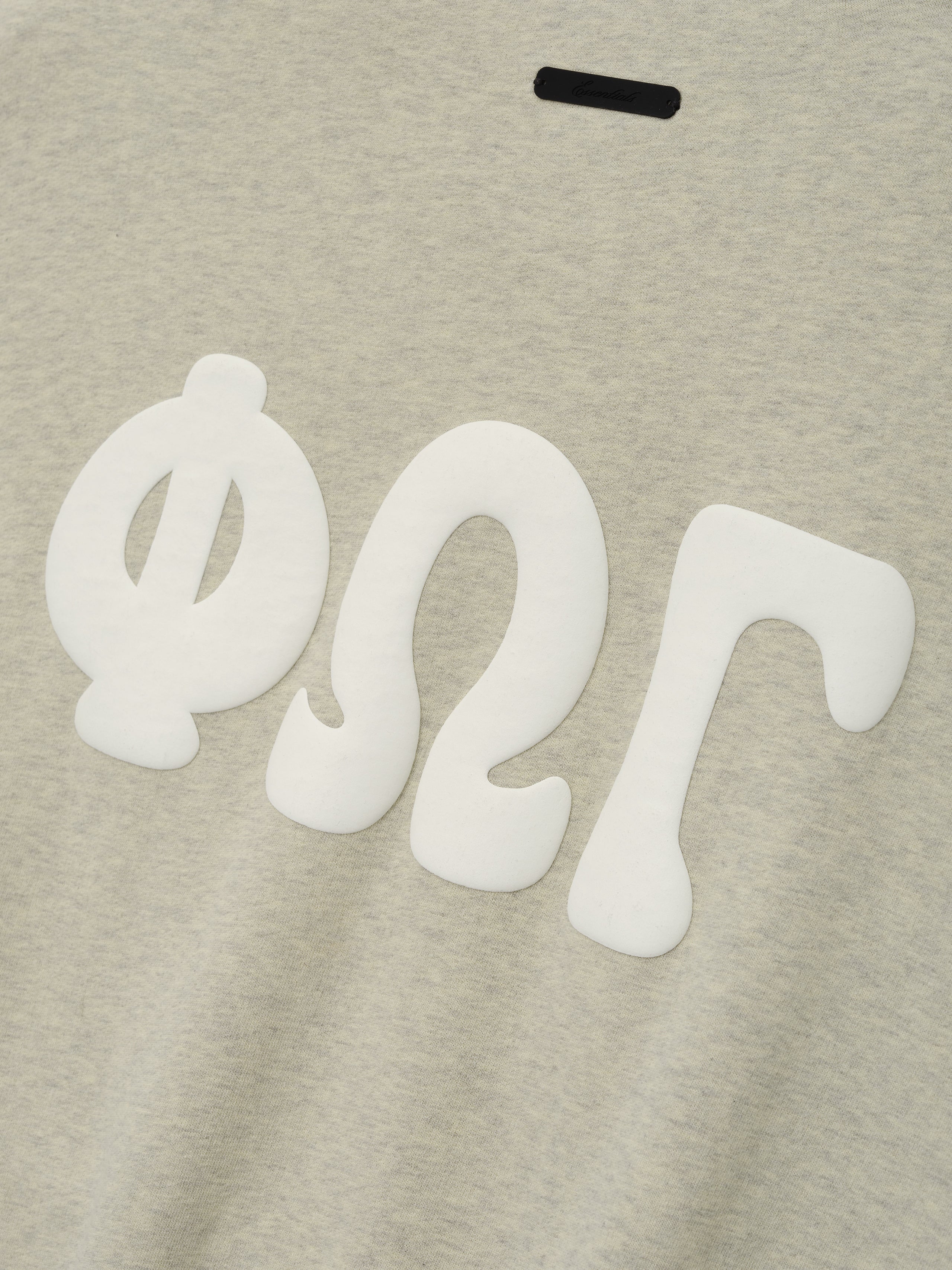 90s Sweatshirt in a soft washed vanilla heather shade, featuring bold white Greek letter appliqués on the front for a distinctive casual top look.