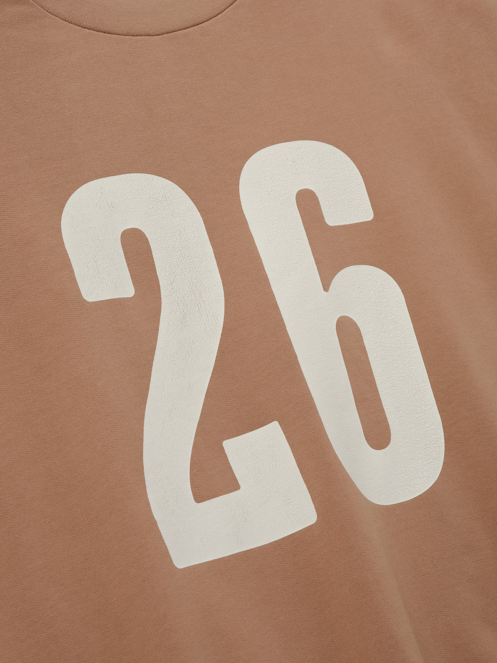 Close-up of a washed ginger 3/4 Sleeve Crewneck showing large, bold white number "26" printed on the front, highlighting soft fabric and casual sporty details.