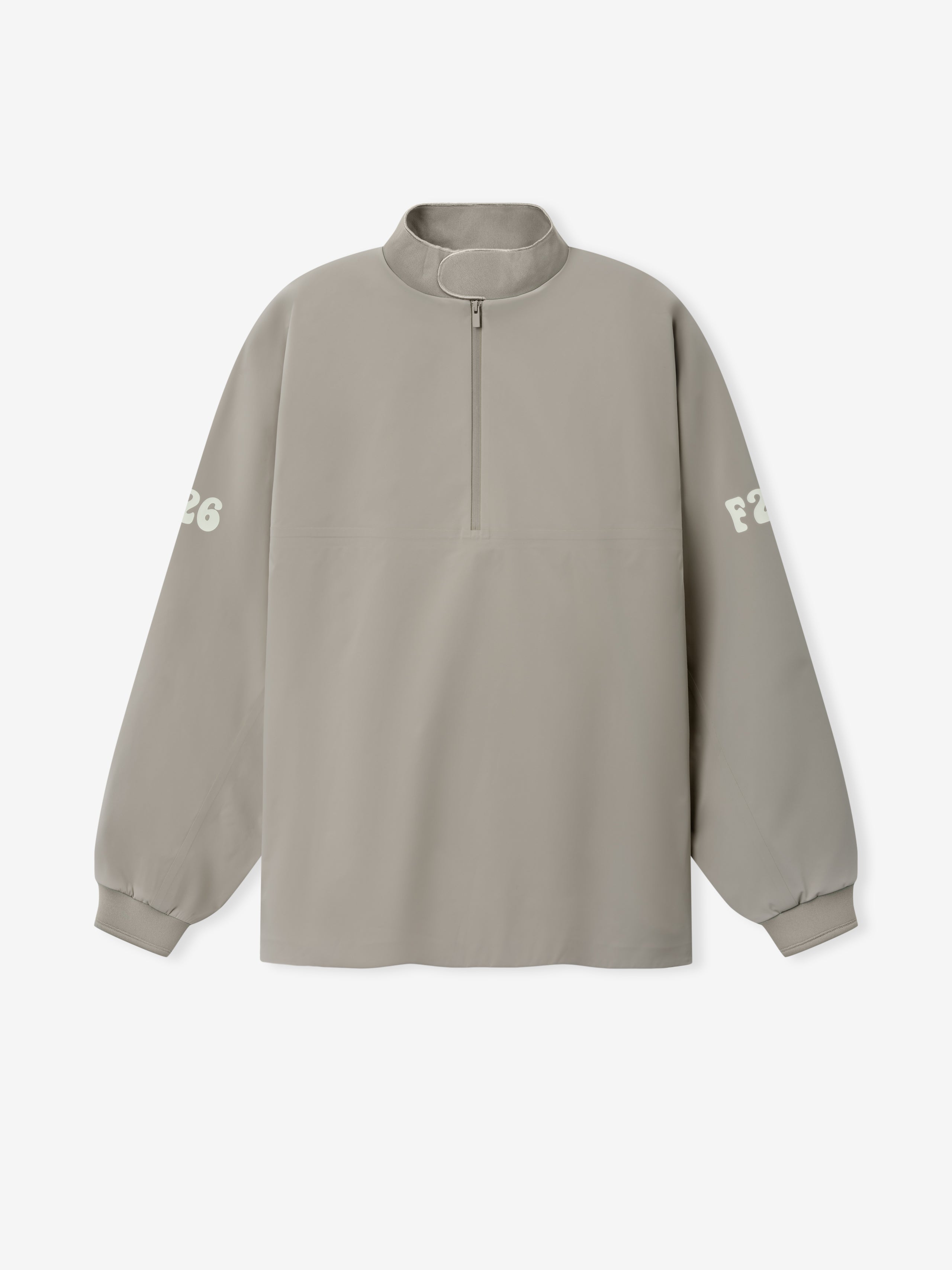 Half Zip Track Jacket in a muted taupe shade featuring a relaxed fit, long sleeves with subtle white printed lettering on each arm, and a front half-zip closure for versatile outerwear.