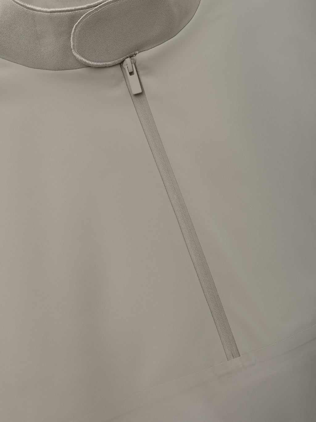 Half Zip Track Jacket in a muted neutral tone featuring a sleek front zipper and smooth fabric texture for a minimalist, modern outerwear option.