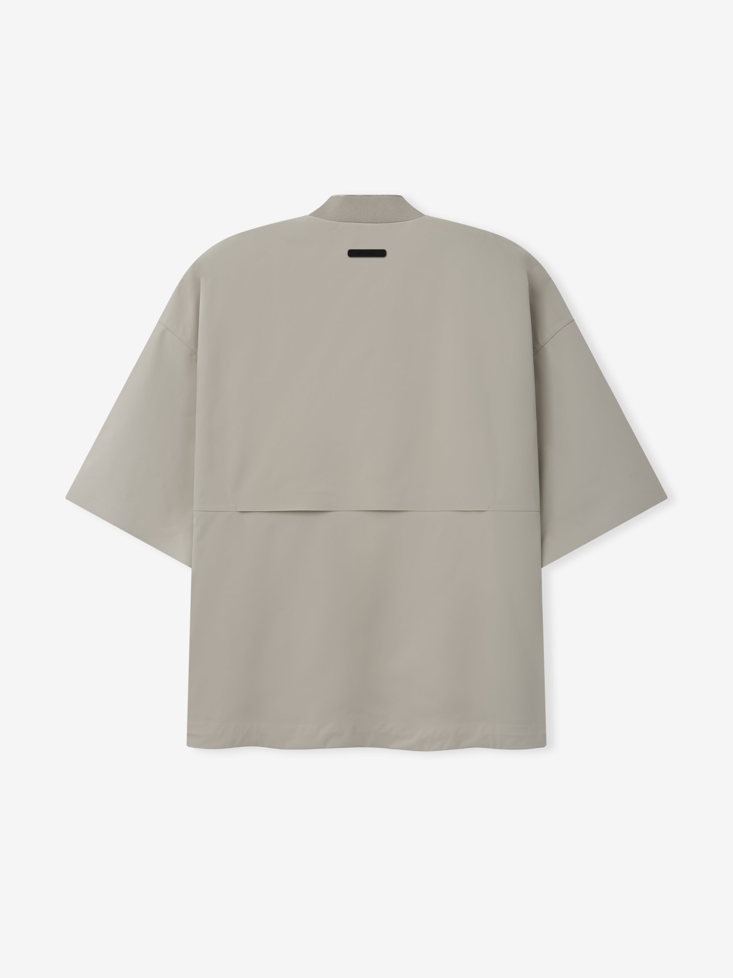 Half Zip Baseball Shirt in a muted neutral shade featuring a relaxed, oversized fit with short sleeves and a vented back panel for enhanced breathability and a modern sporty look.