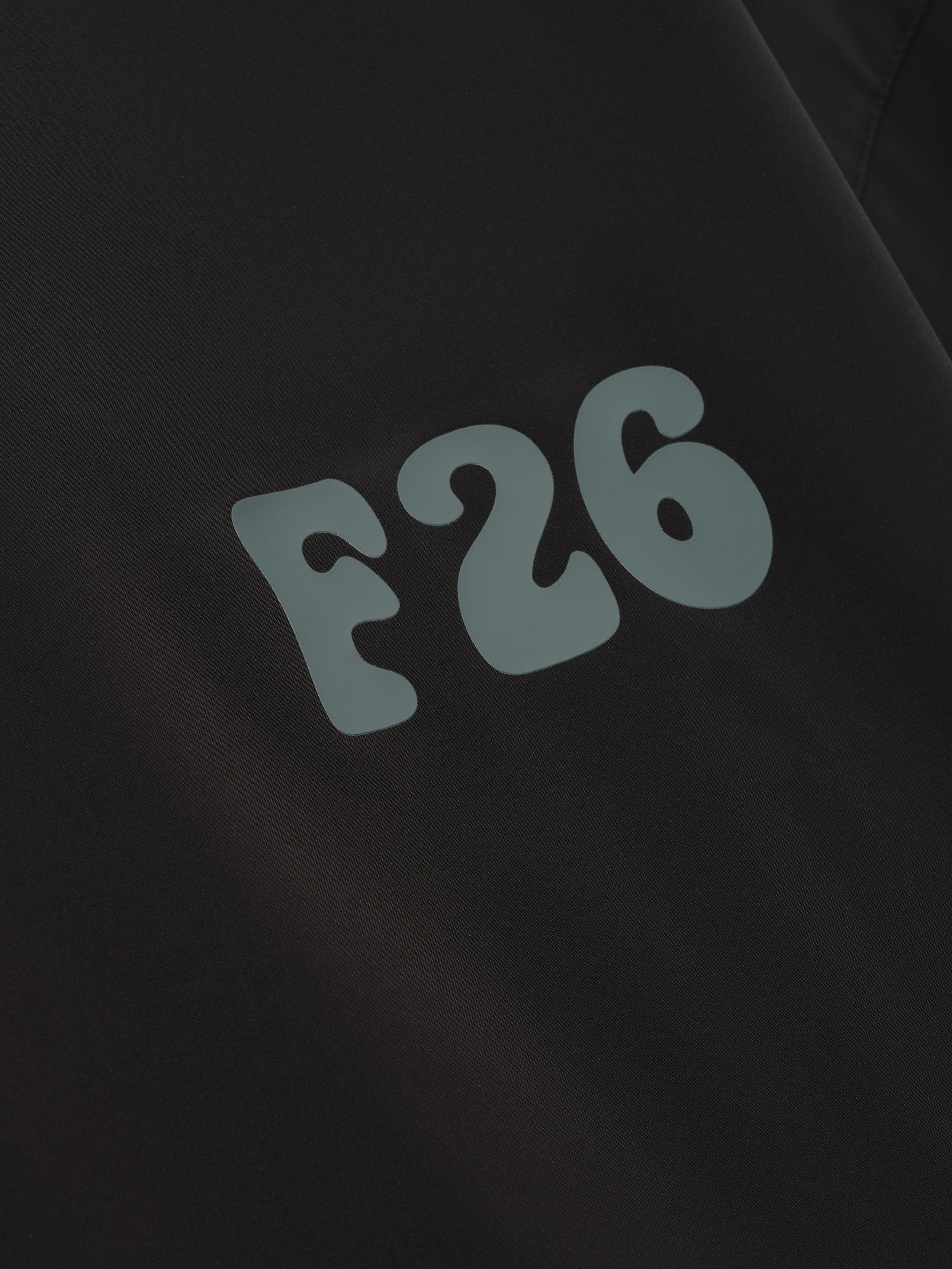 Half Zip Baseball Shirt in a dark hue featuring smooth fabric with bold, stylized light-colored lettering “F26” for a distinctive modern sporty top.