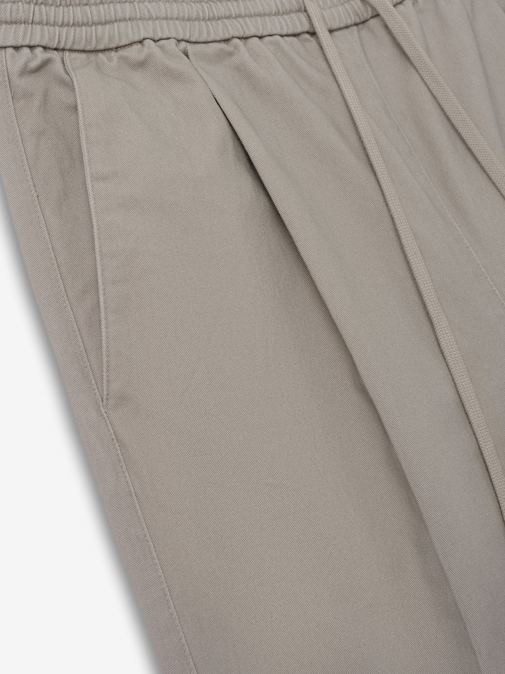 Silk Blend Pleat Front Drawstring Pant in a muted seal tone, featuring side pockets, subtle front pleats, and an elastic waistband with adjustable drawstring for comfortable suiting bottoms.