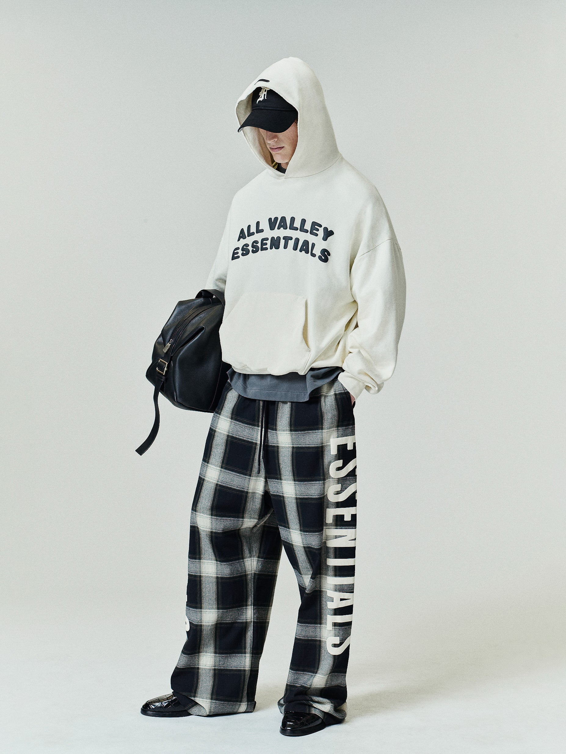 Flannel Lounge Pant in a vintage black and white plaid design with a wide-leg silhouette and prominent cream-colored vertical lettering along the side for a relaxed, stylish fit.