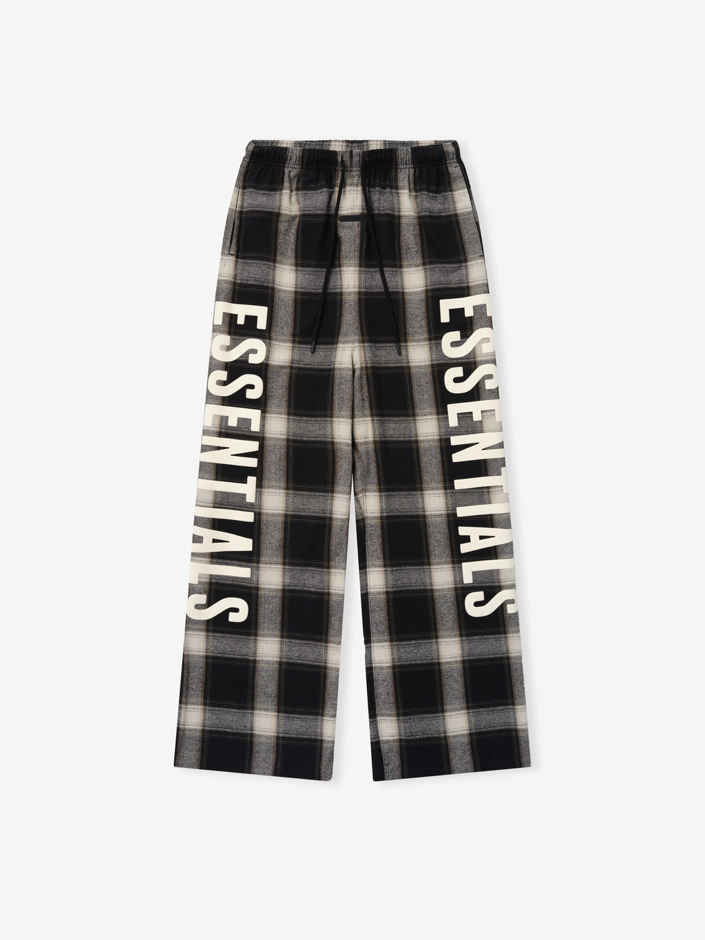 Flannel Lounge Pant in black and gray plaid with a relaxed fit, featuring an elastic waistband and bold cream-colored vertical "ESSENTIALS" lettering along each leg.