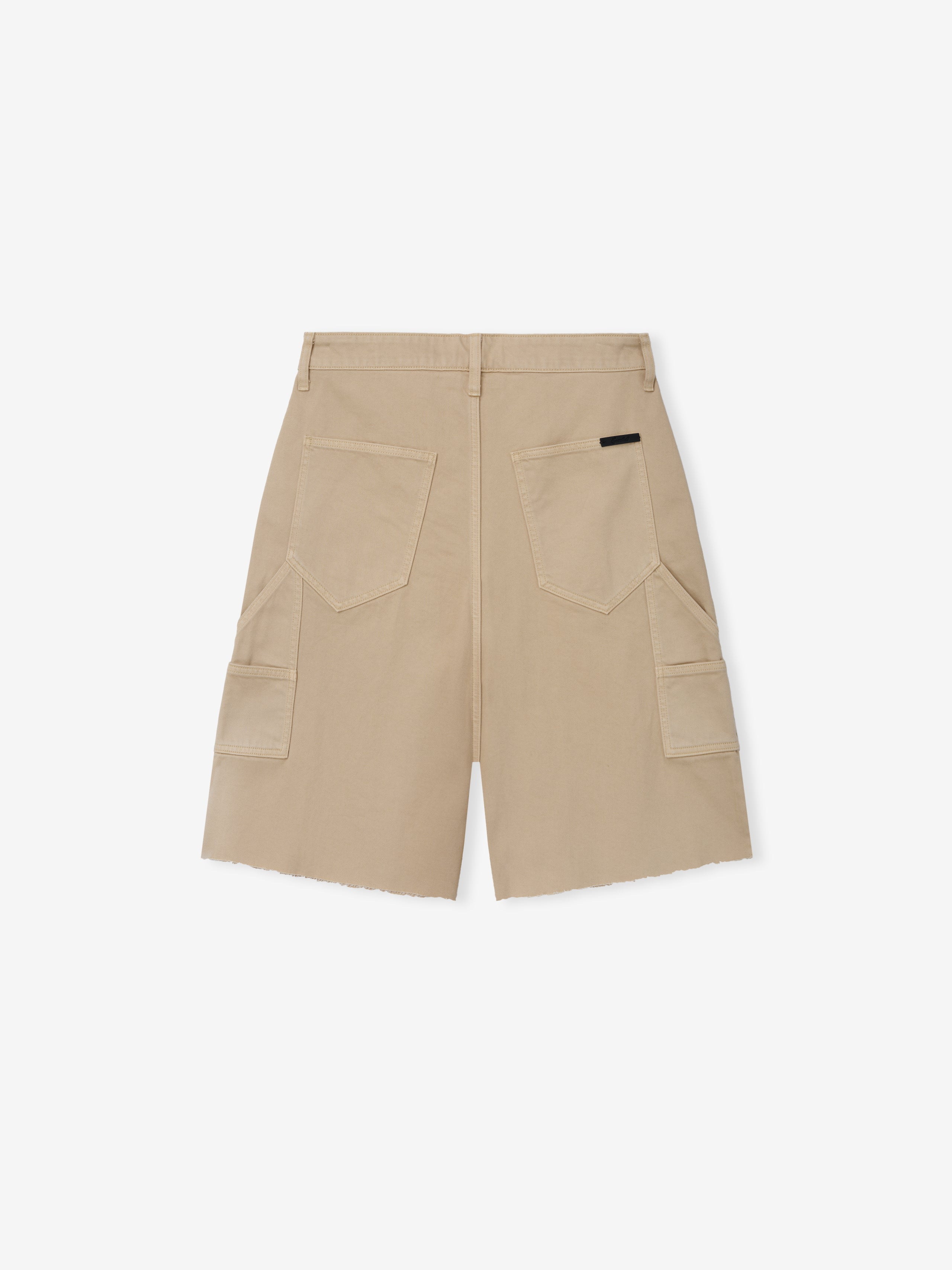Raw Cut 5-Pocket Short in a soft dune shade, featuring two back patch pockets, side cargo pockets, belt loops, and a raw hem for a relaxed casual bottoms style.