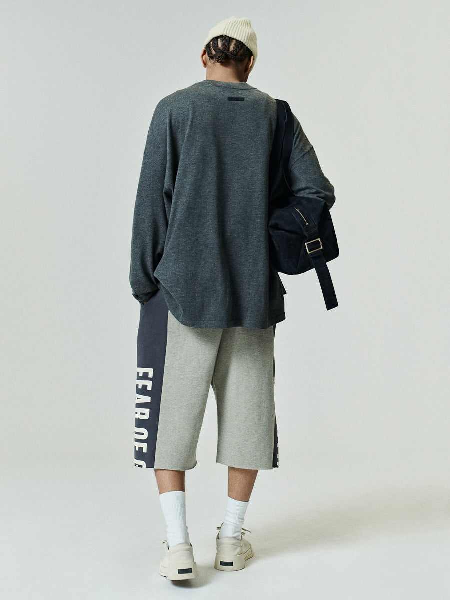 Soft Knit Long Sleeve Tee in a muted dark grey, featuring a relaxed fit and soft knit fabric, styled with casual shorts and a beanie for a laid-back look.